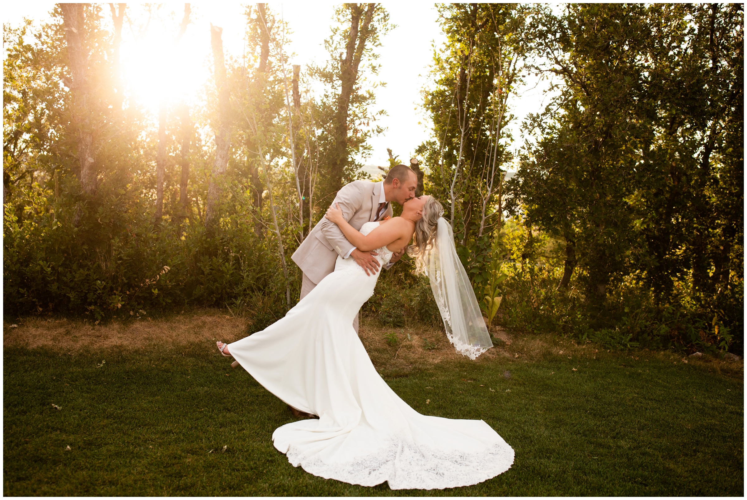 groom dipping bride with sun in the background during romantic wedding portraits at the Oaks at Plum Creek