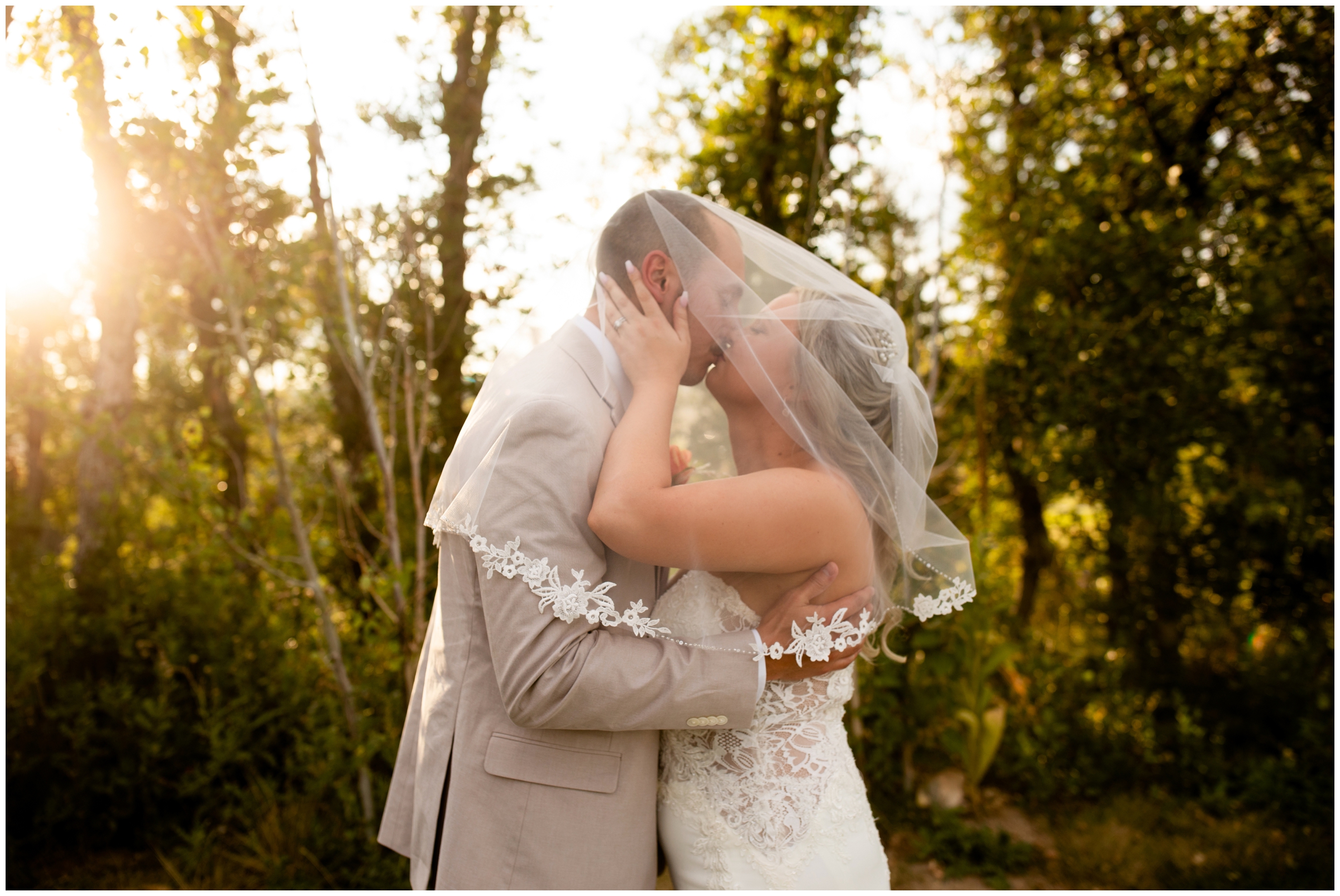 bride and groom kissing under bride's veil during romantic wedding pictures at the Oaks at Plum Creek 