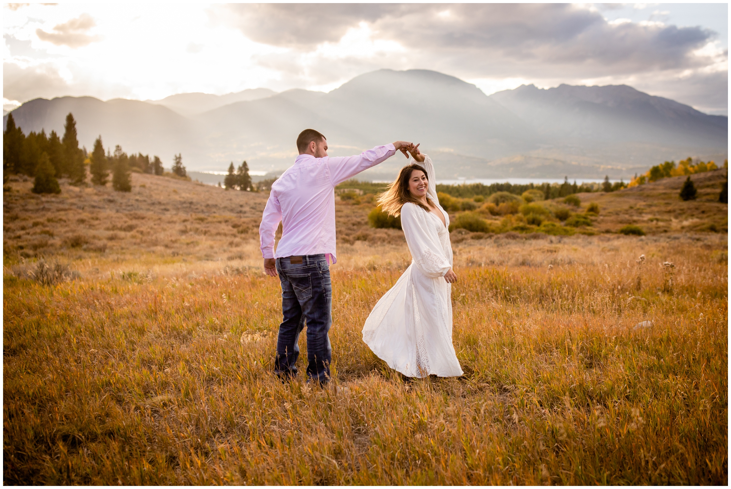 couple dancing in a field at windy point campground during their Breckenridge Colorado fall engagement photos 