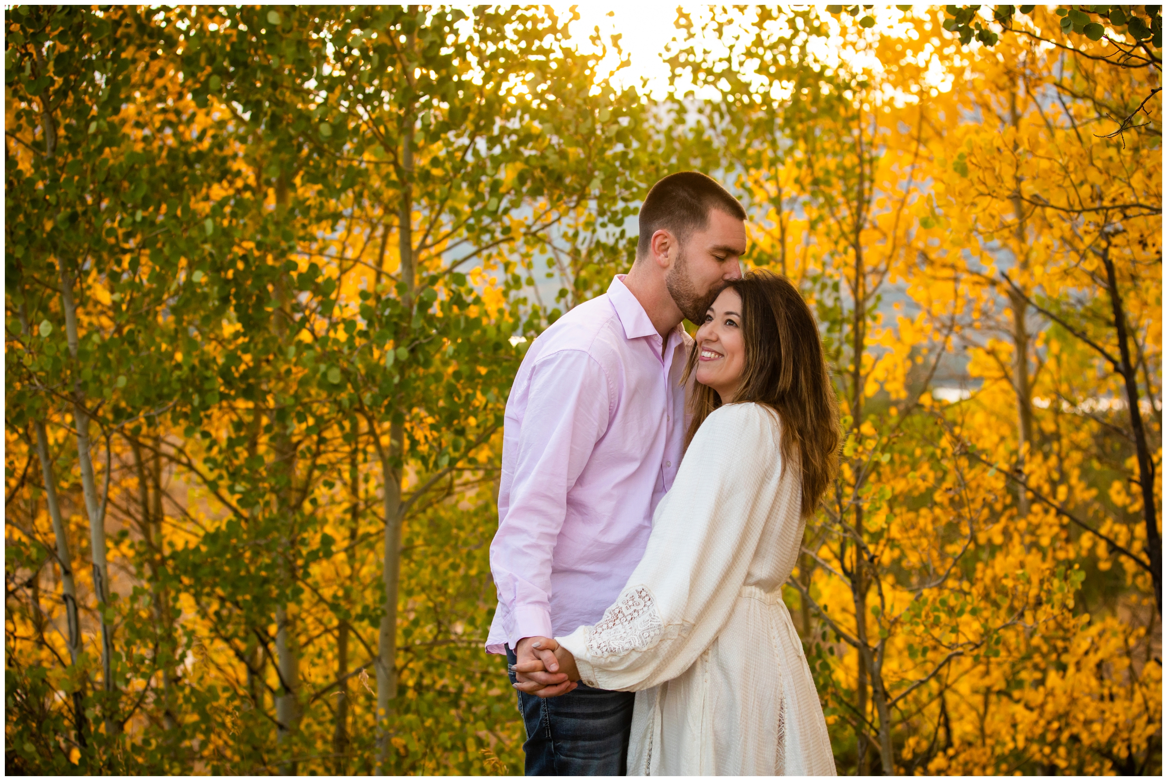 couple cuddling in an aspen grove during fall engagement photography session in Breckenridge Colorado 