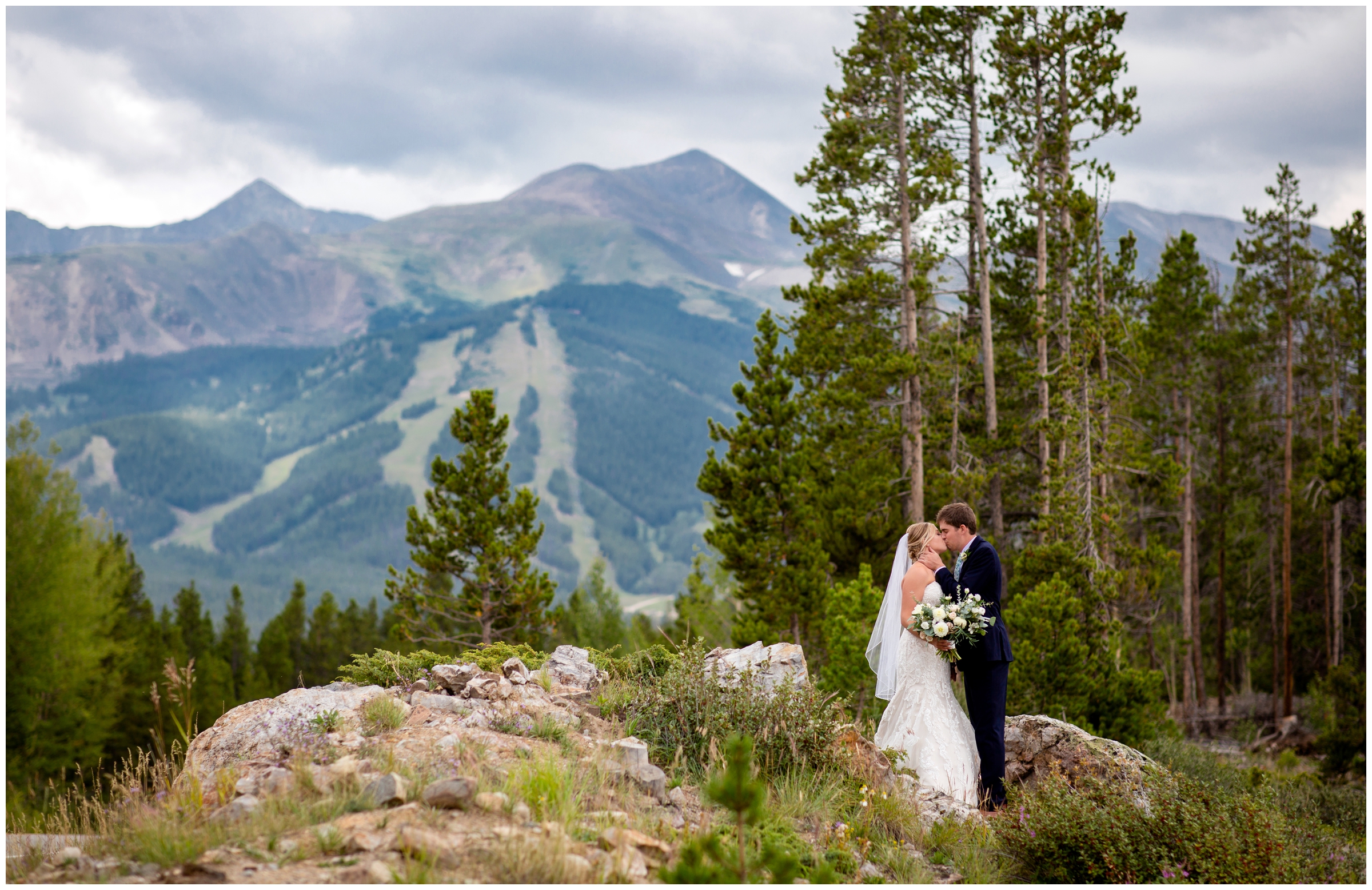Colorado couple posing on a mountaintop during Lodge at Breckenridge wedding photos by Plum Pretty Photography 