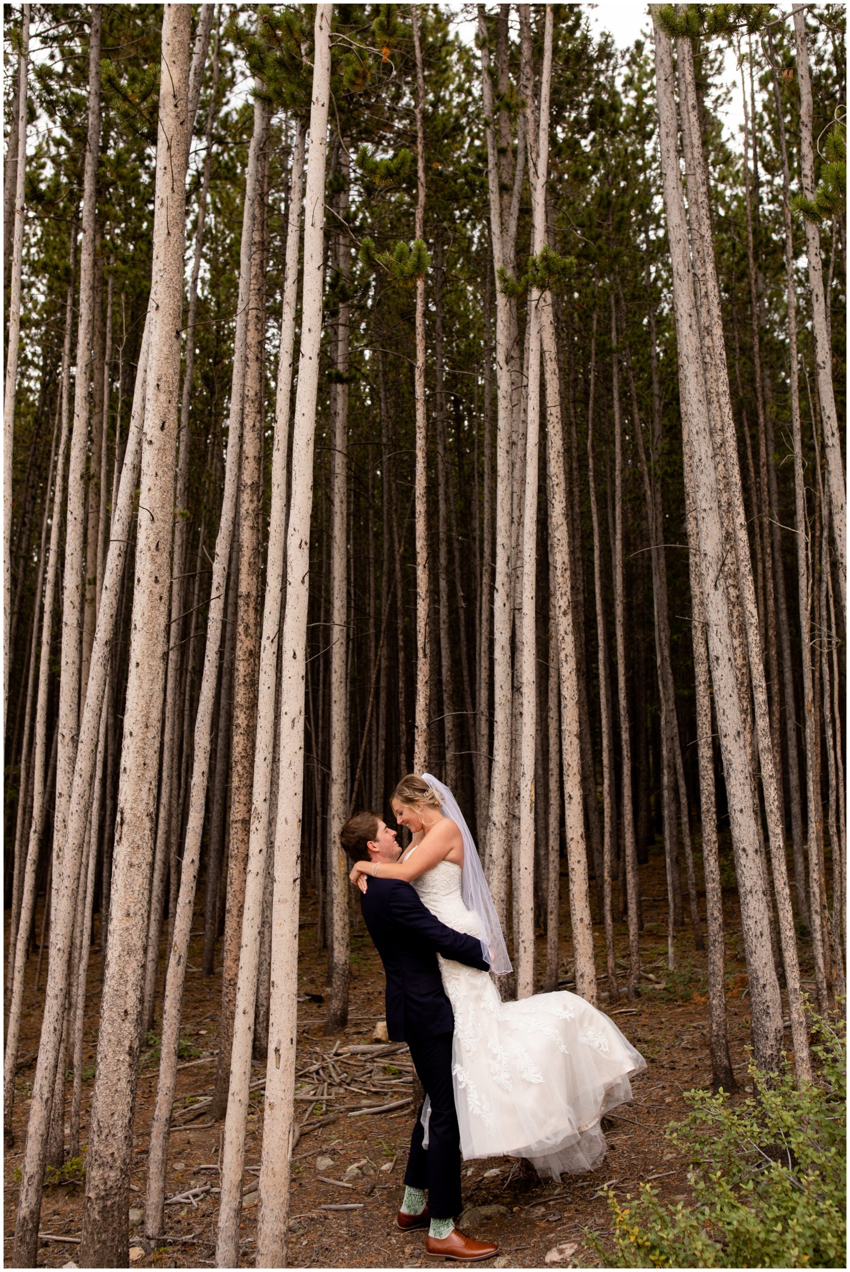 groom lifting bride in the forest during Breckenridge Colorado summer wedding pictures by Plum Pretty Photography 
