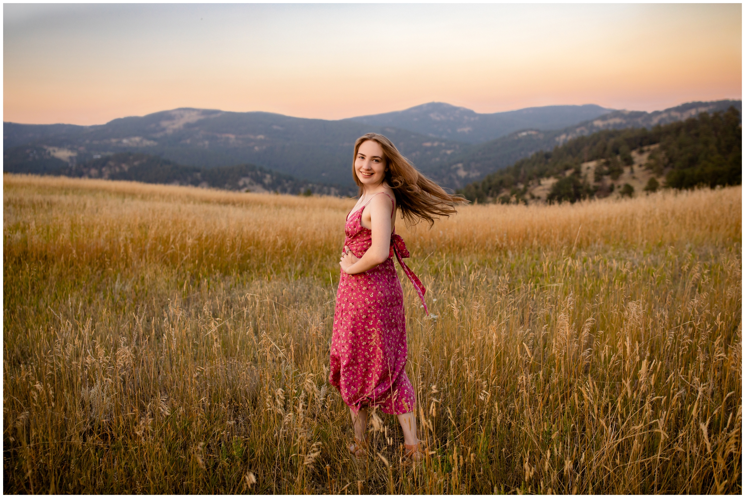 teen girl twirling in field at sunset during Colorado mountain senior portraits 