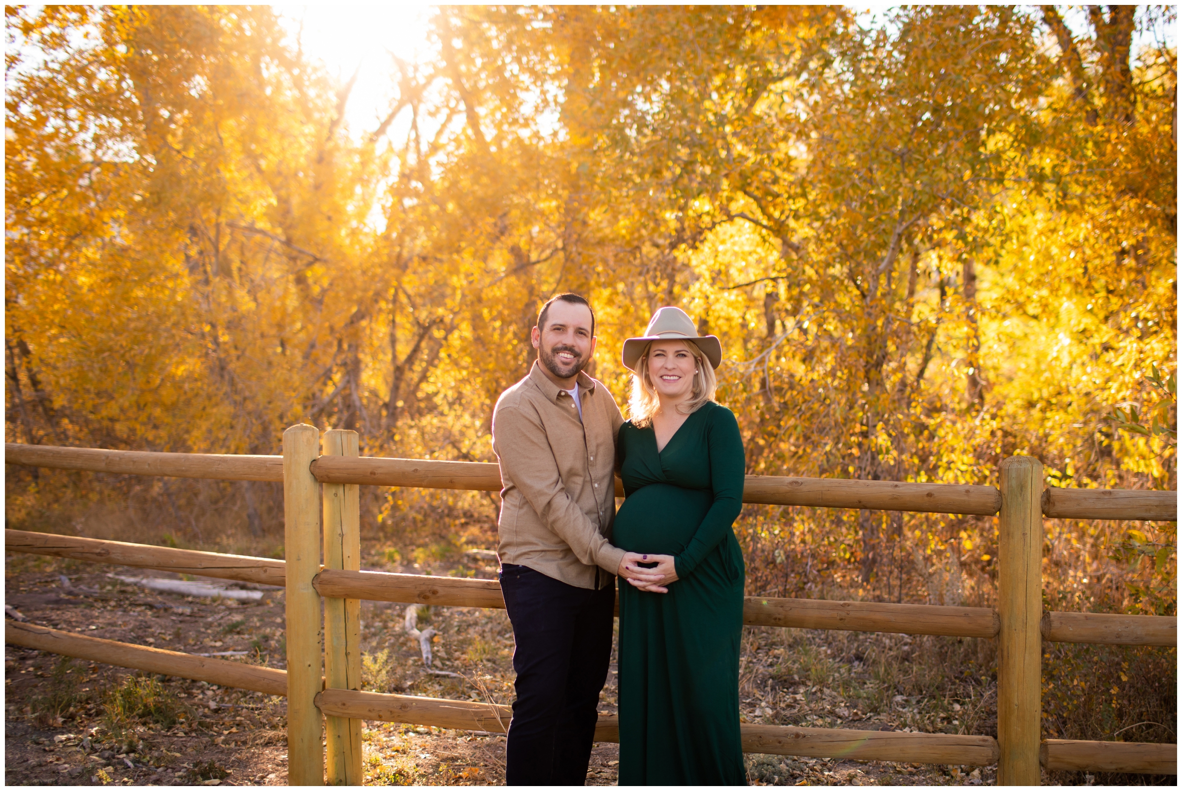 couple posing in front of colorful fall foliage during Boulder maternity portraits at South Mesa Trail by Colorado photographer Plum Pretty Photography