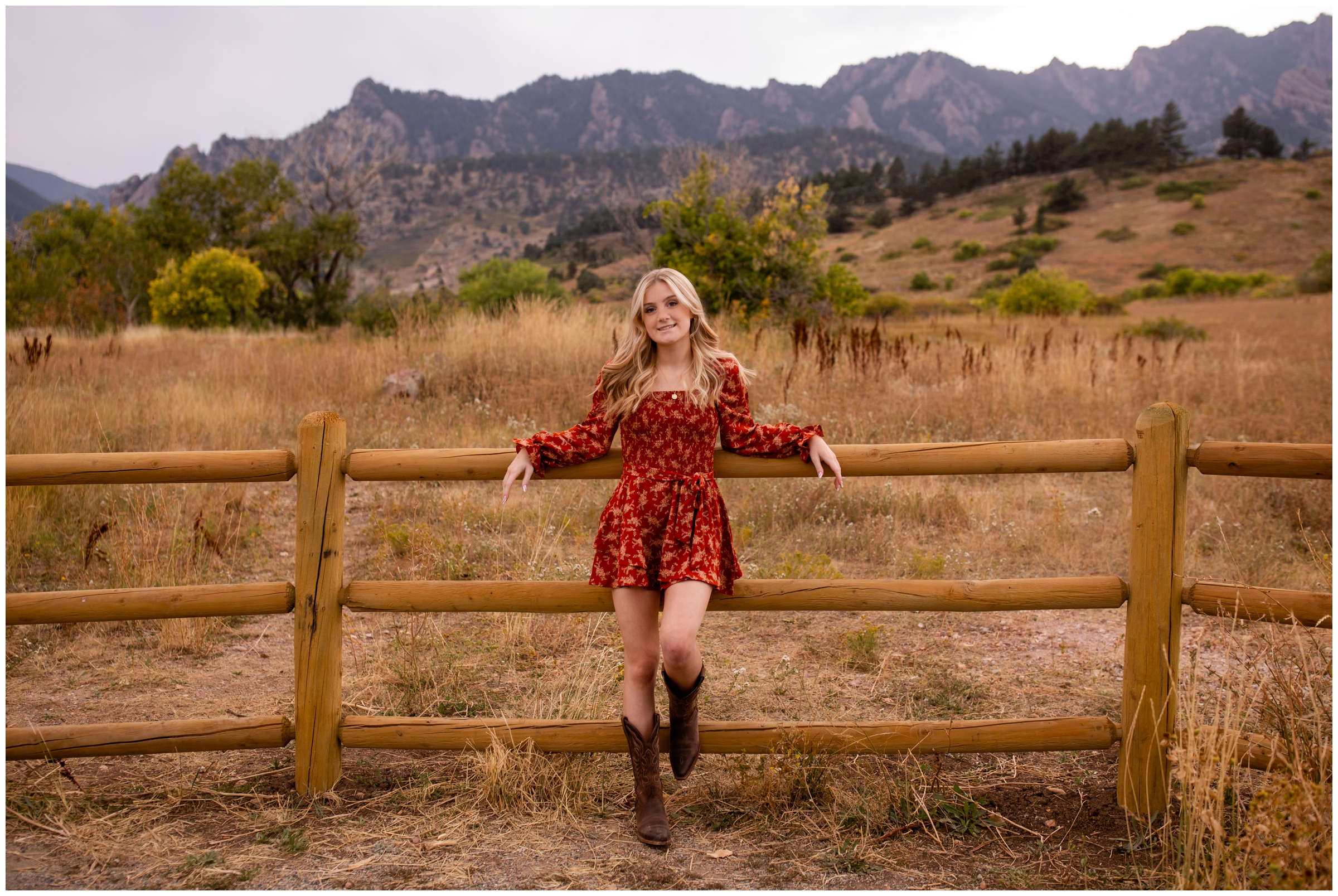 teen girl leaning against wooden fence during Senior portraits in Boulder at South Mesa Trail by Colorado photographer Plum Pretty Photography