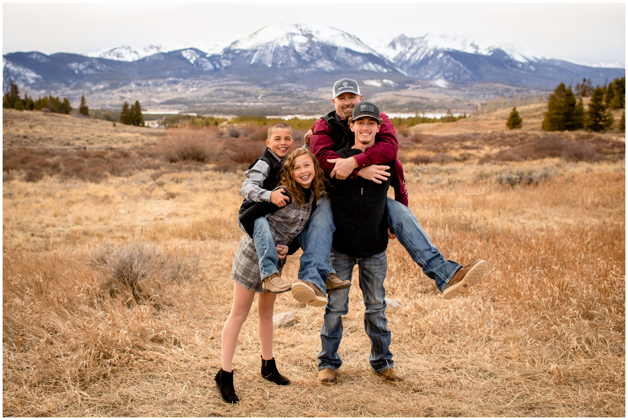 kids giving piggy back rides during candid family photos in Breckenridge Colorado 