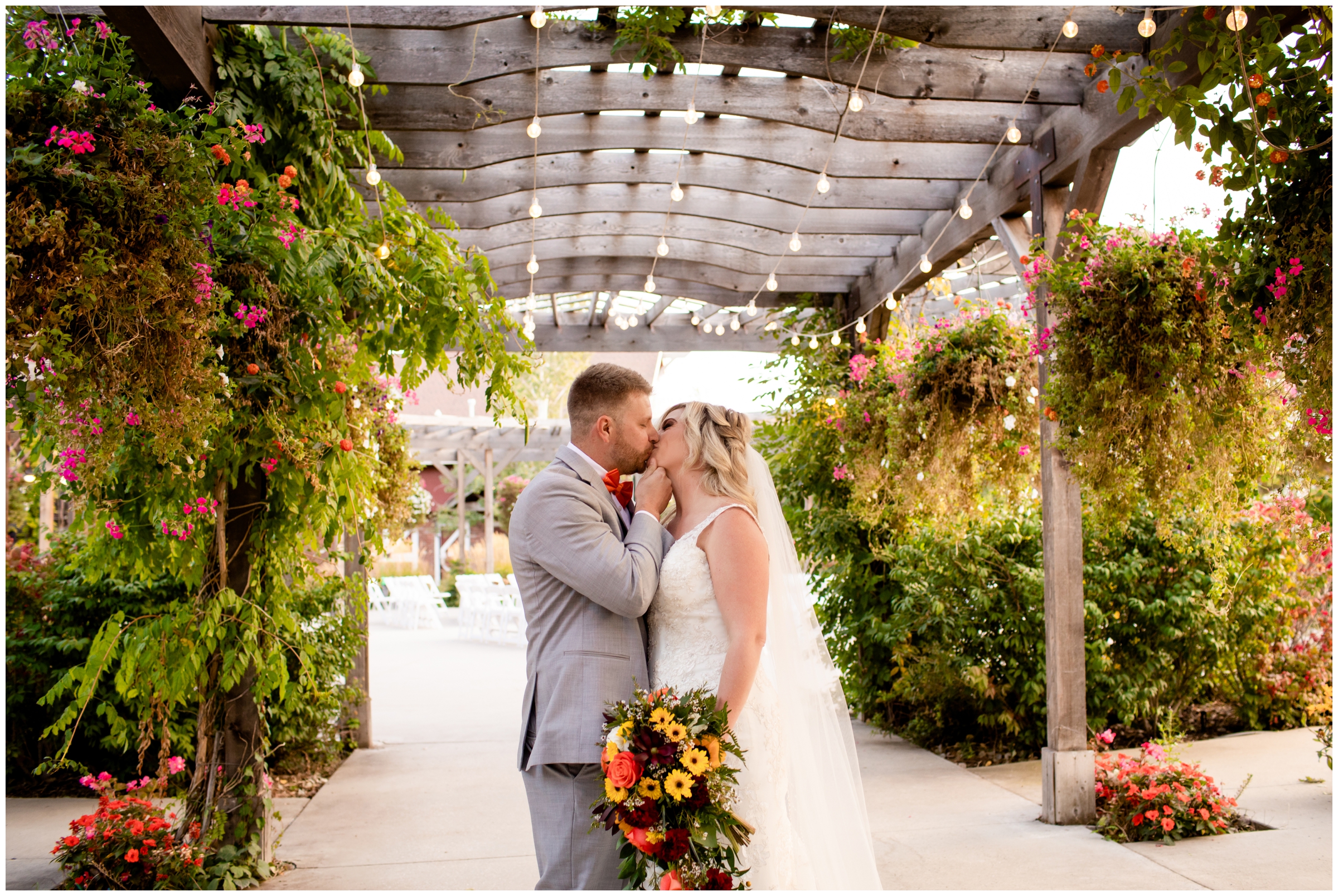couple kissing during pavilion at Brookside Gardens wedding in Berthoud Colorado 
