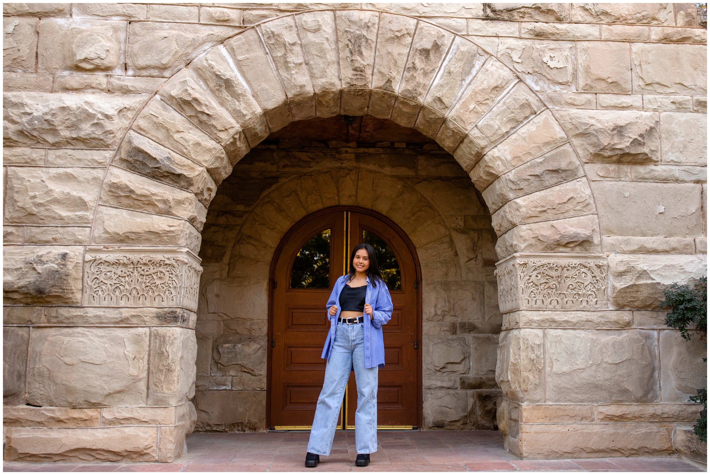 teen posing under stone archway during CU Boulder senior photos by Colorado portrait photographer Plum Pretty Photography