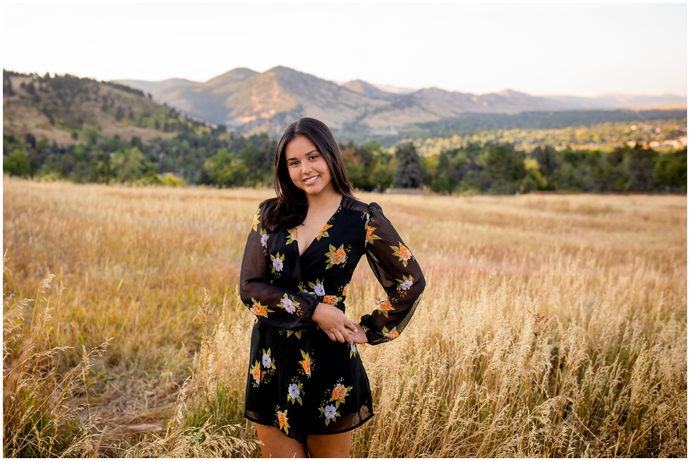 teen posing in field of long grasses during Colorado mountain senior pictures in Boulder