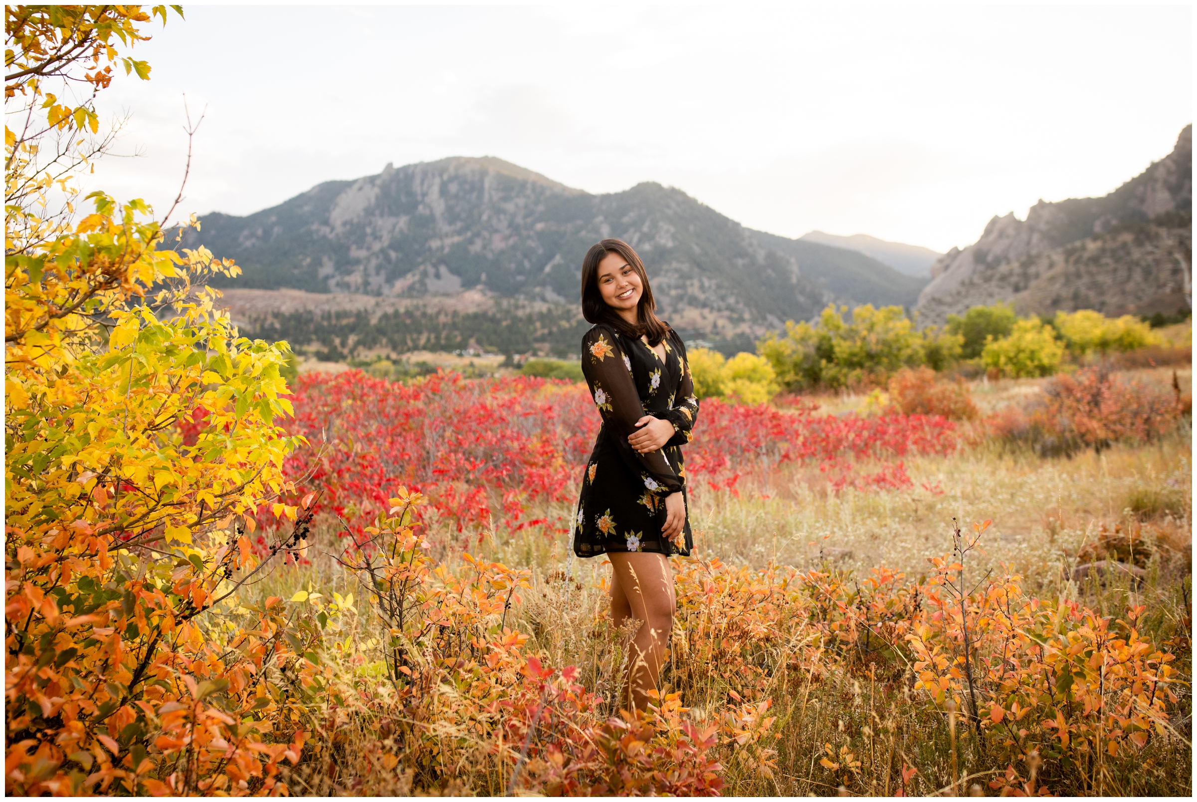 teen posing amongst red sumac fall foliage at South Mesa Trail senior photos in Boulder Colorado