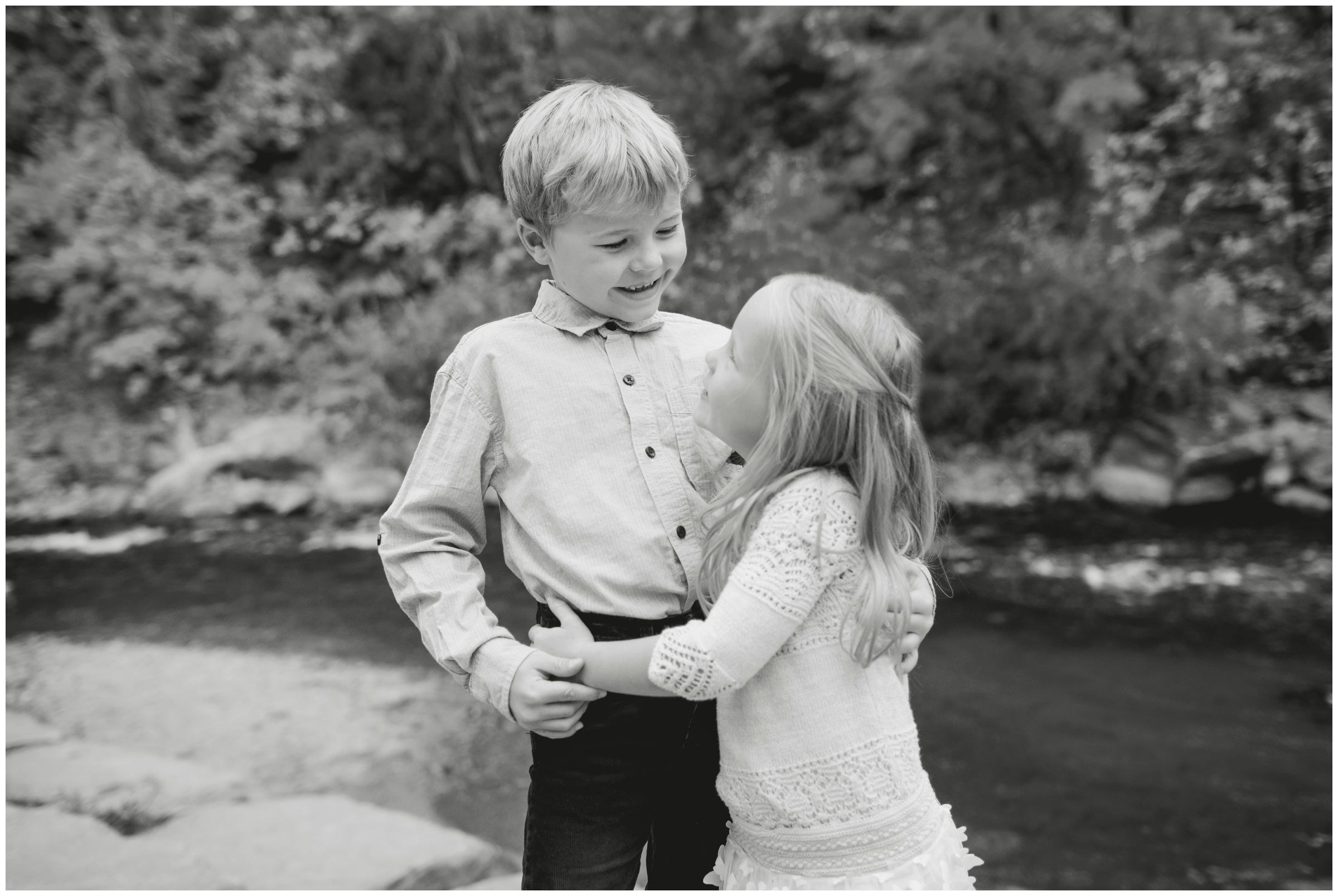 siblings hugging during candid family photos in Colorado by Plum Pretty Photography 