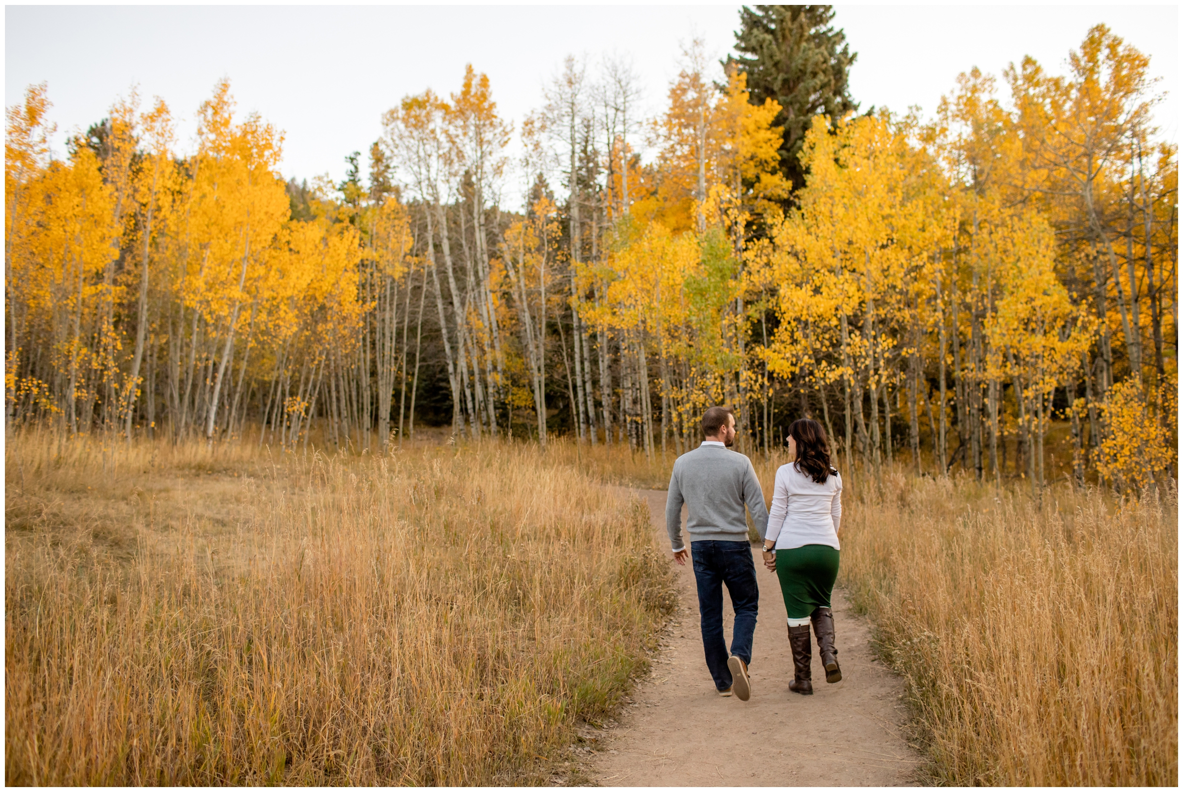 couple walking in aspen grove at Meyer Ranch Park Colorado 