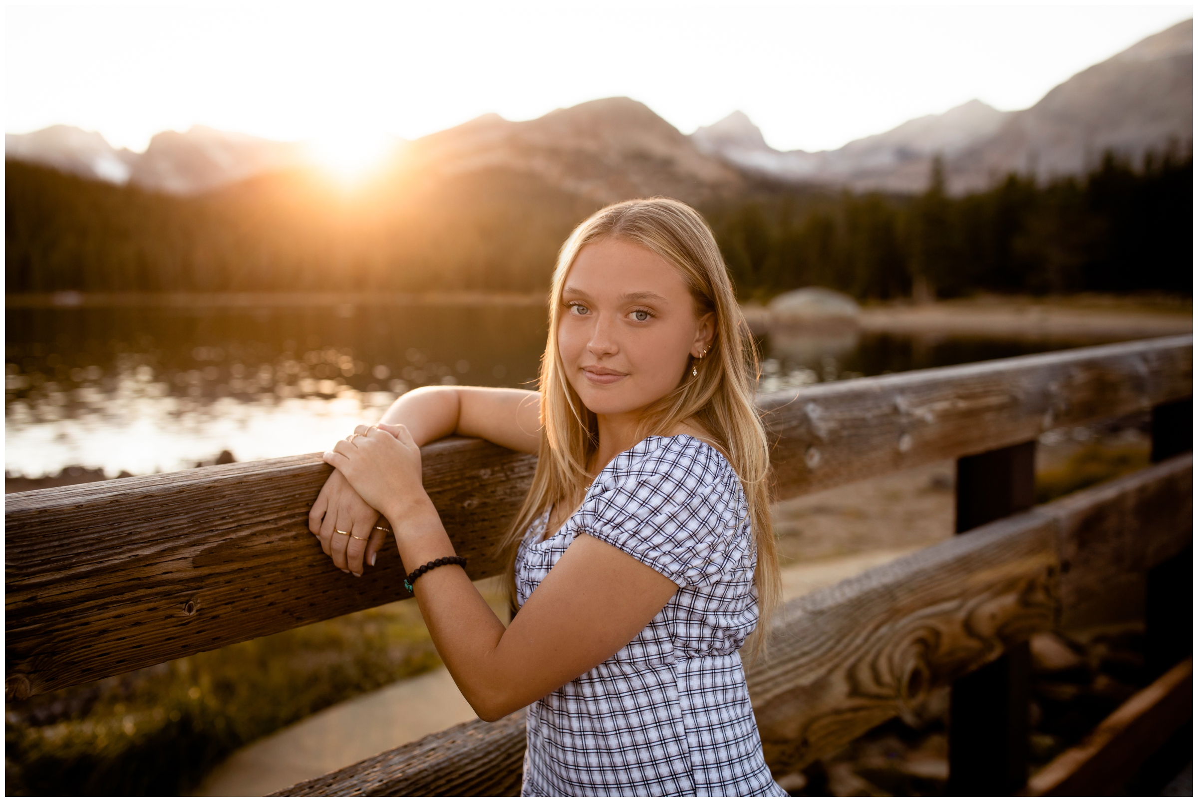 teen leaning against wooden bridge at Brainard Lake during Colorado mountain senior photos 