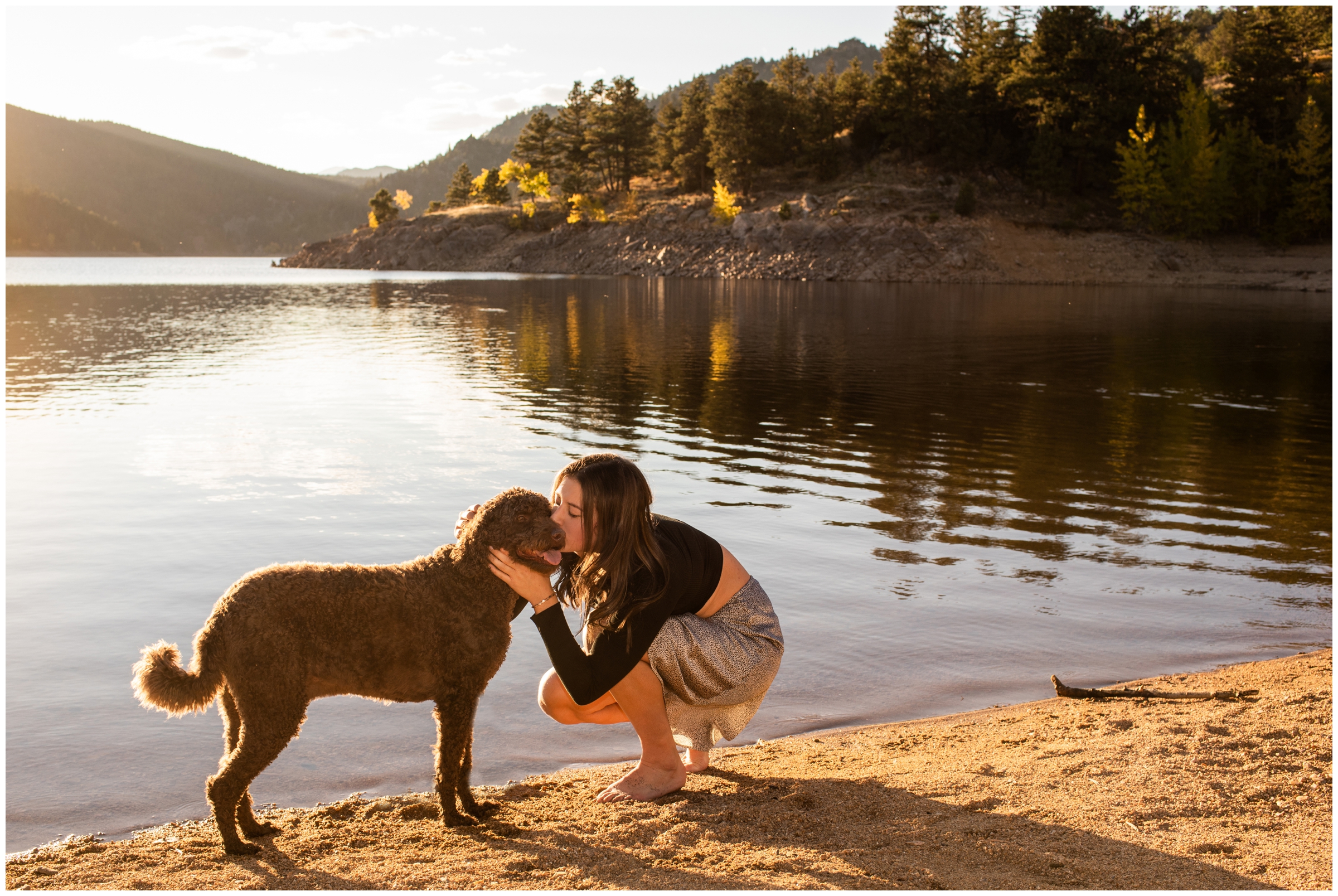 teen kissing her dog during Boulder Colorado senior pictures at Gross Reservoir 
