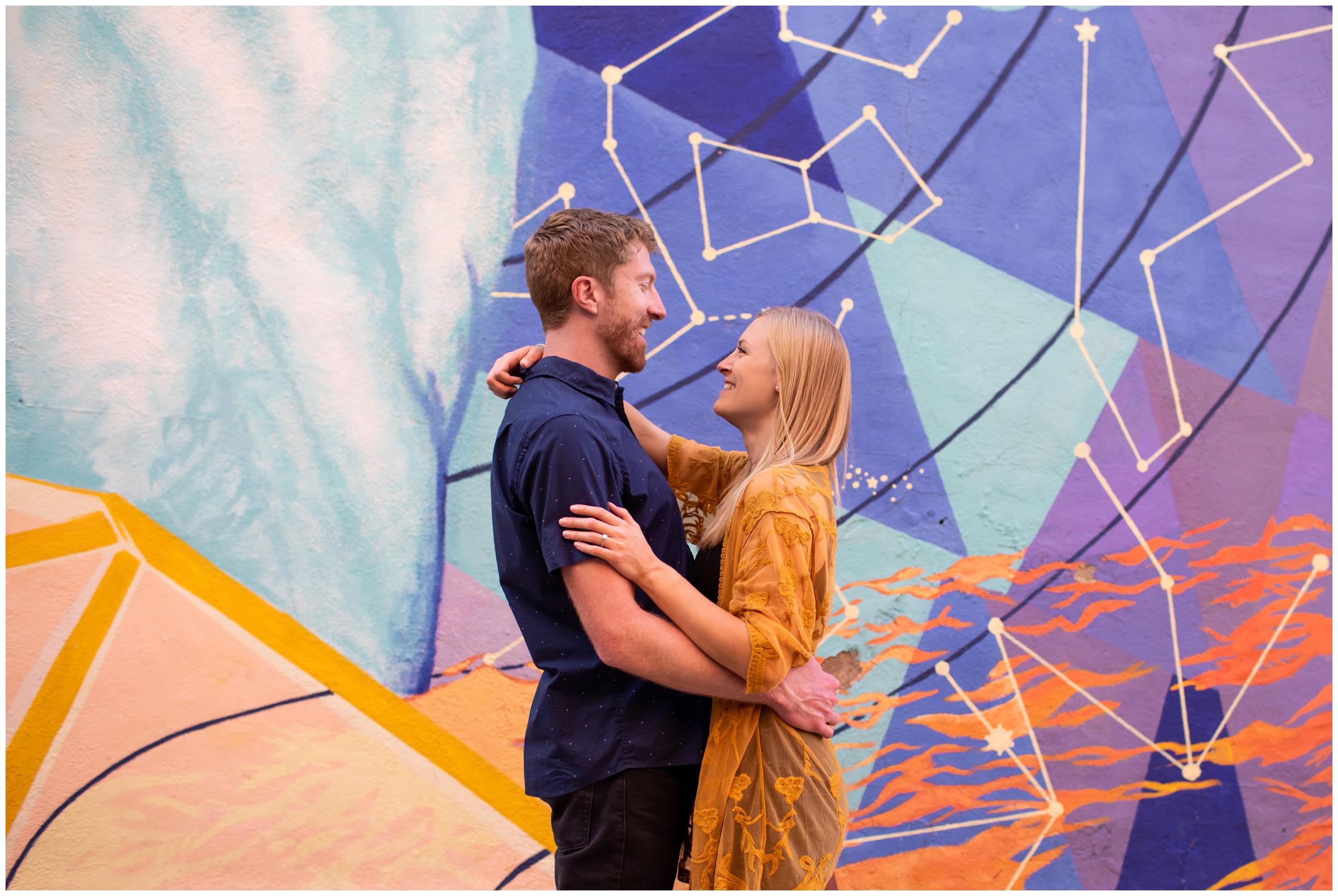 urban engagement portraits in front of a colorful wall mural in Fort Collins Colorado