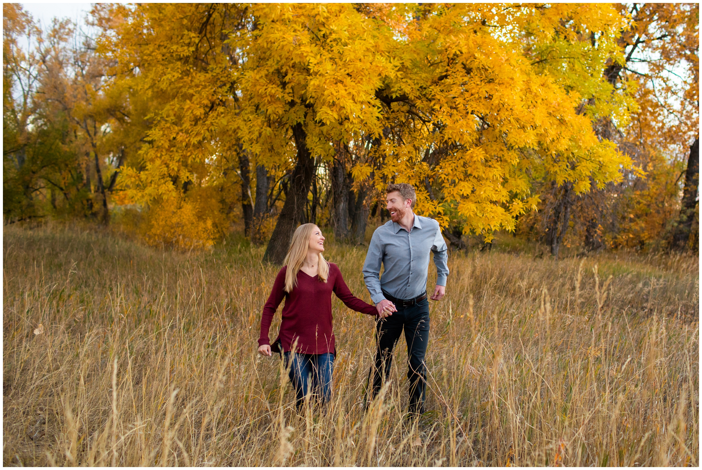 couple running through a field during Ft. Collins Colorado engagement pictures at Riverbend Ponds