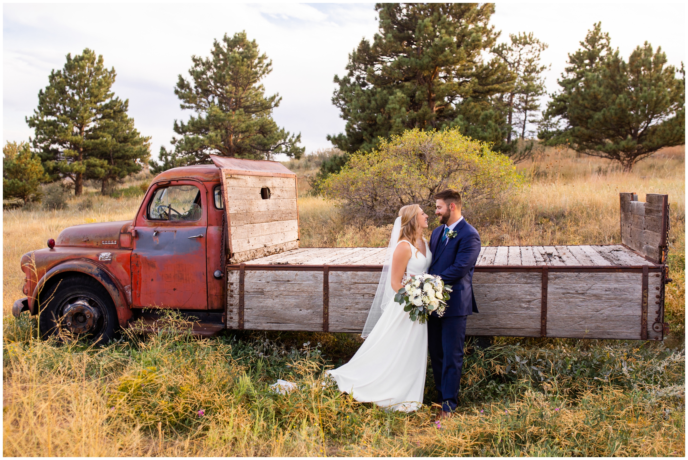 bride and groom posing in front of vintage truck during Lyons Colorado wedding pictures