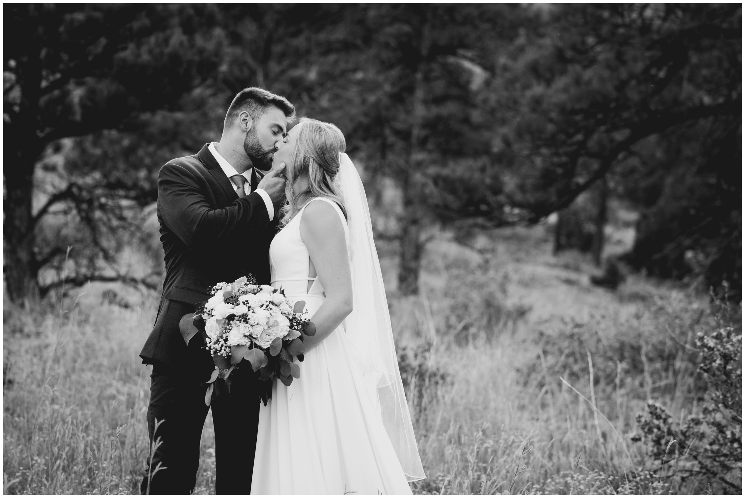 couple kissing during Colorado forest wedding photography