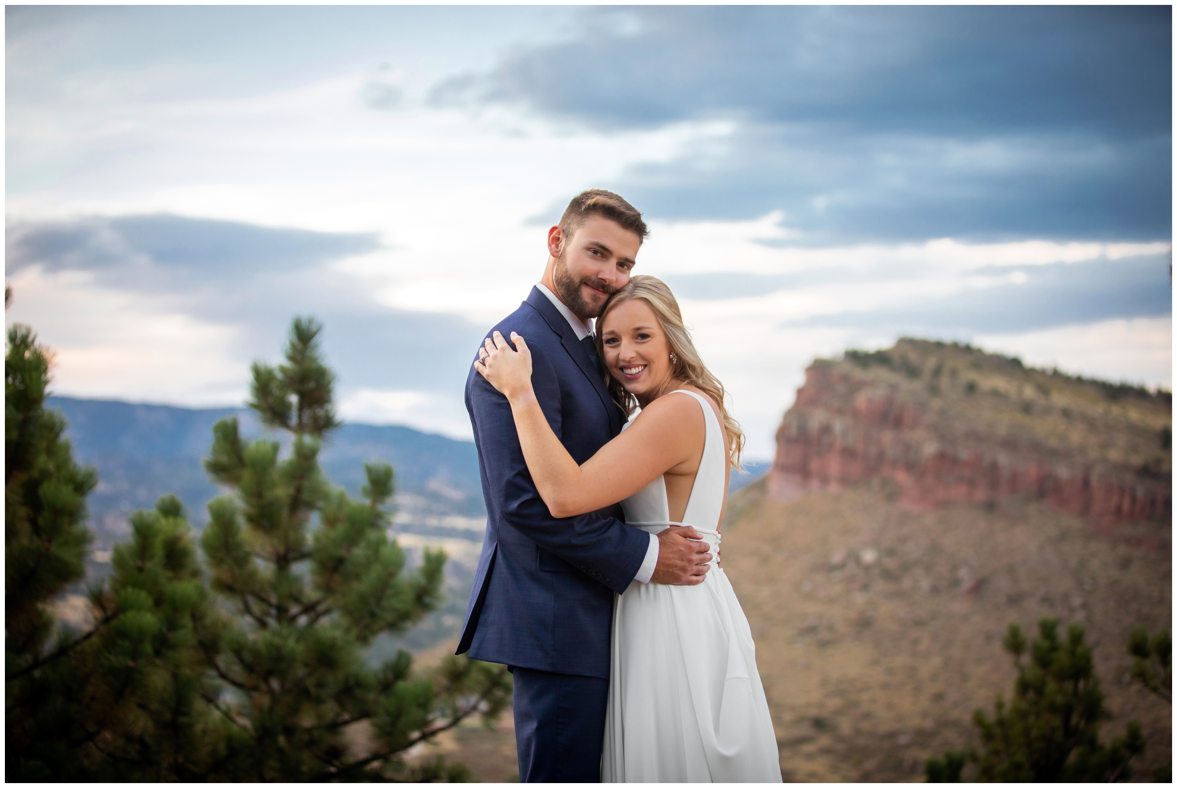 couple embracing on top of mountain at sunset during Lionscrest Manor wedding portraits