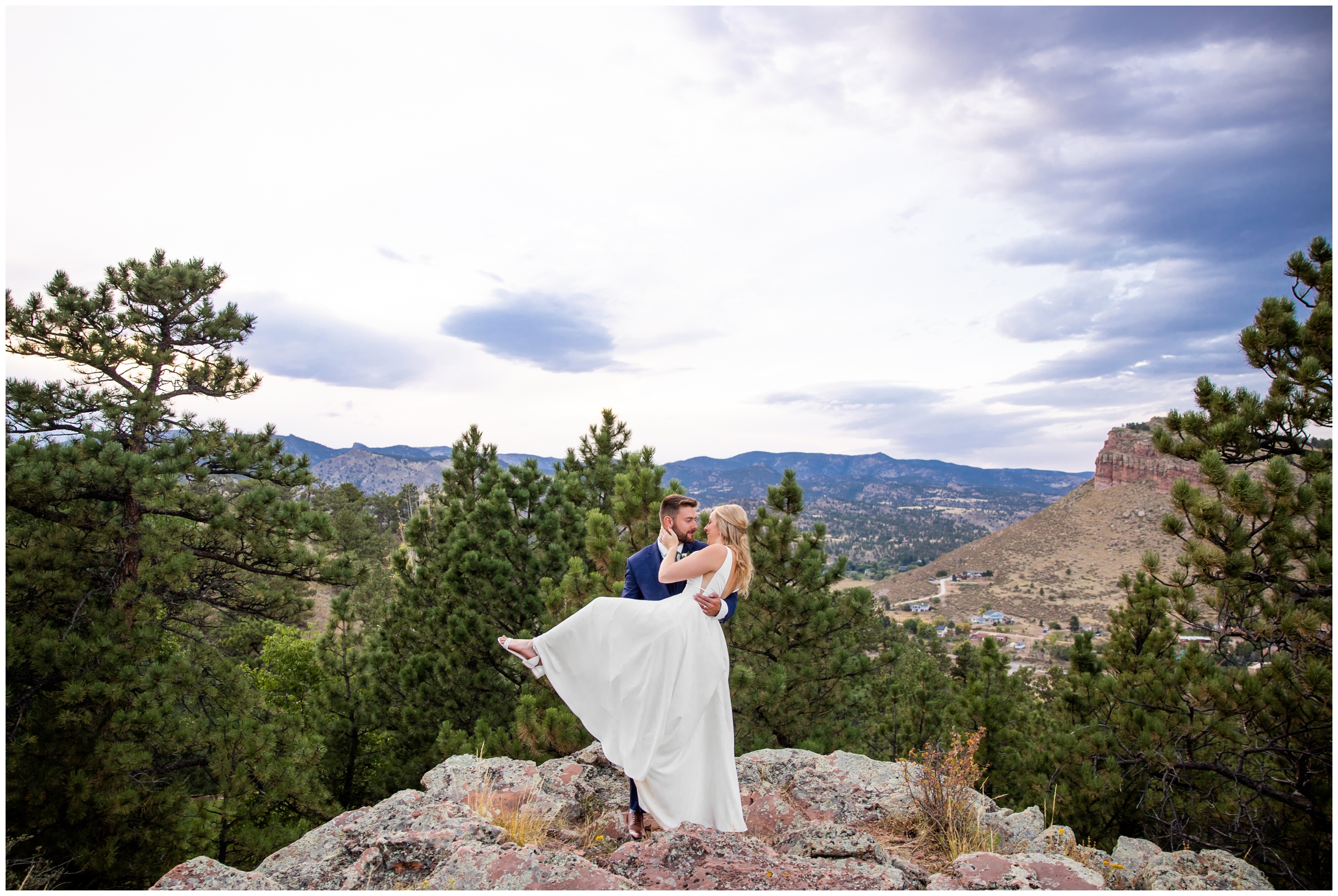 groom lifting bride on mountaintop during Lyons Colorado wedding pictures
