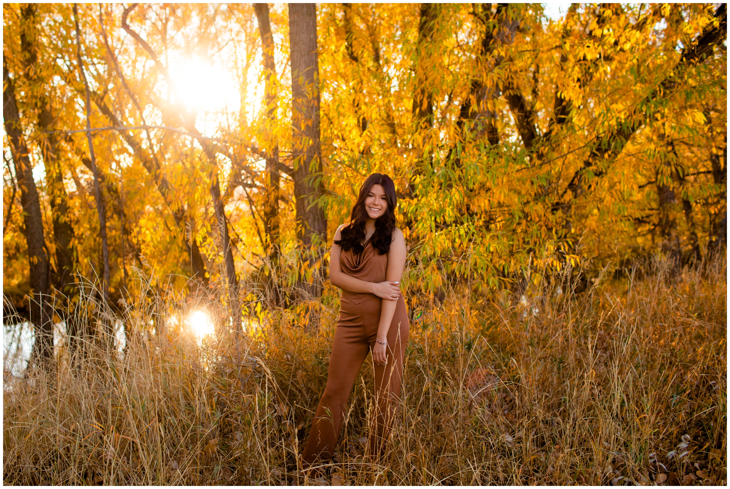 teen posing against colorful fall foliage during Longmont Colorado senior pictures 