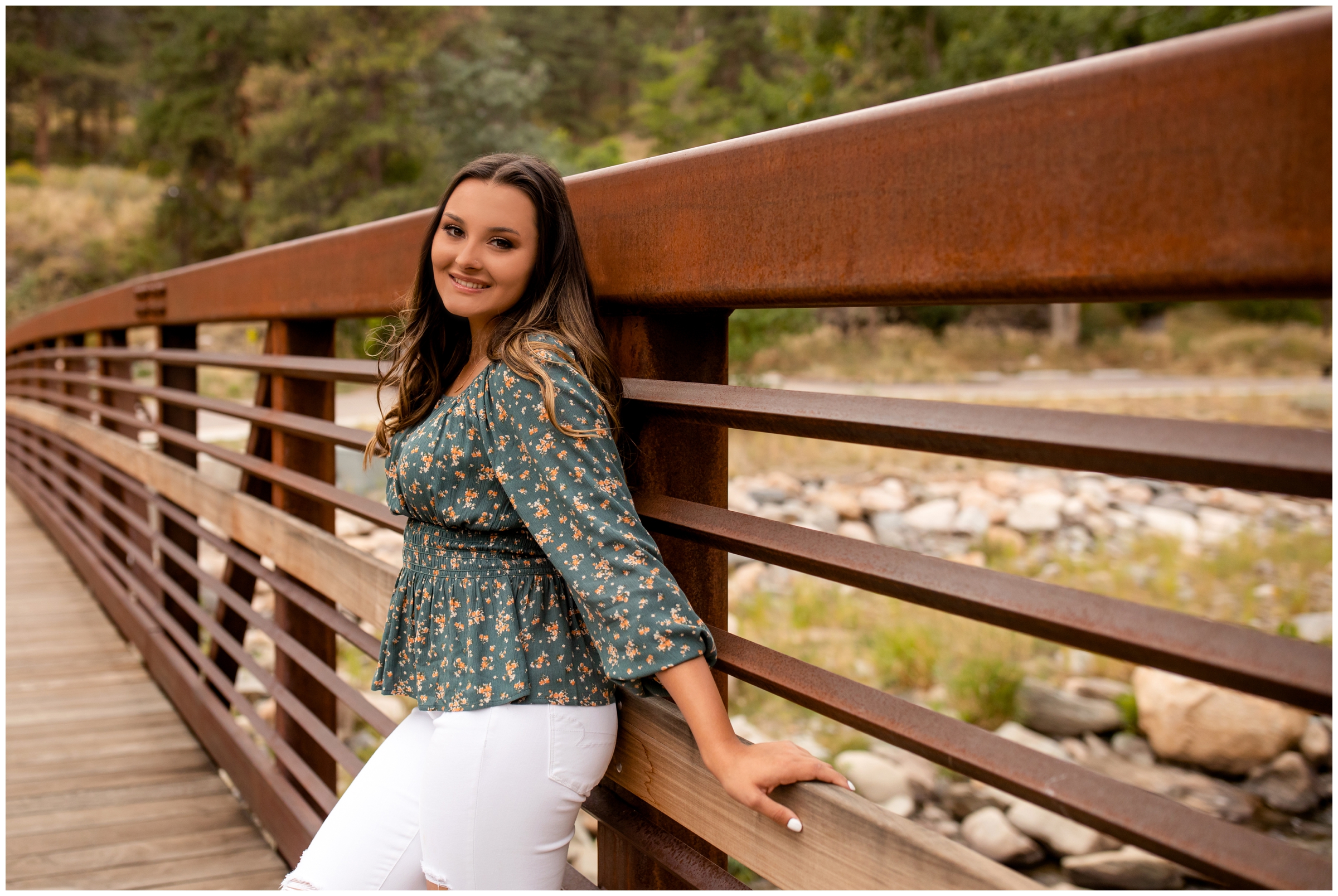 teen girl posing on bridge during Loveland senior photos at Viestenz-Smith mountain park