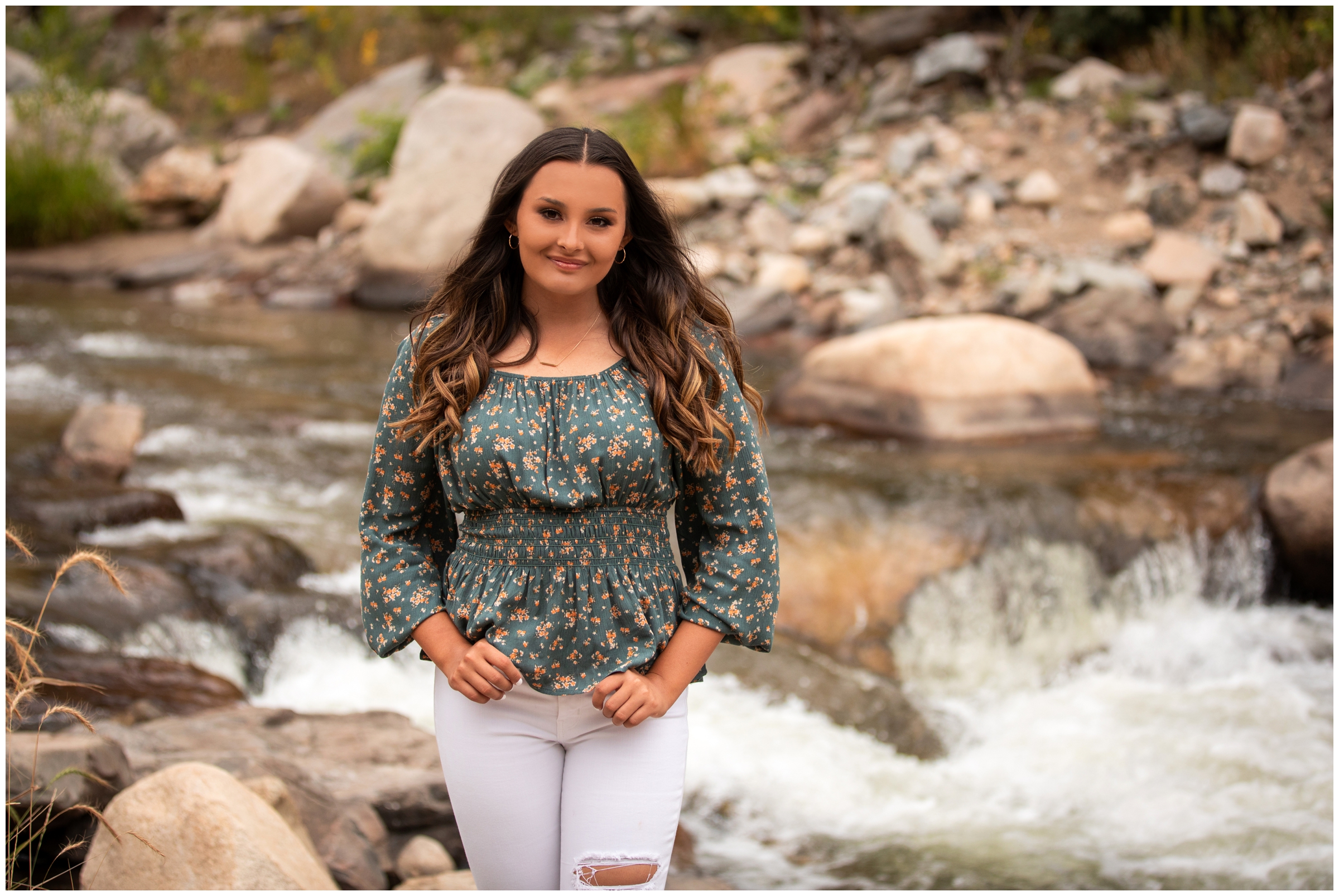 teen posing next to a river during Loveland Colorado high school senior photos