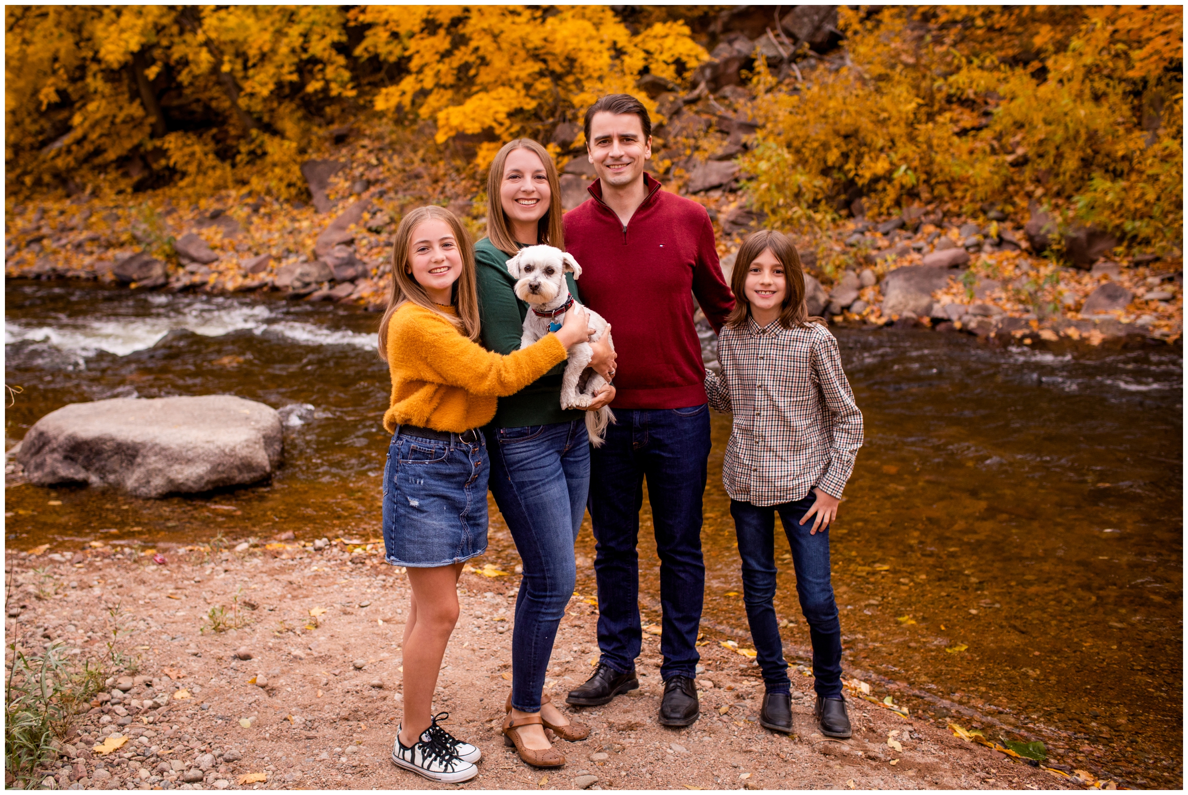 family posing next to river during Colorado fall family portraits in Lyons CO
