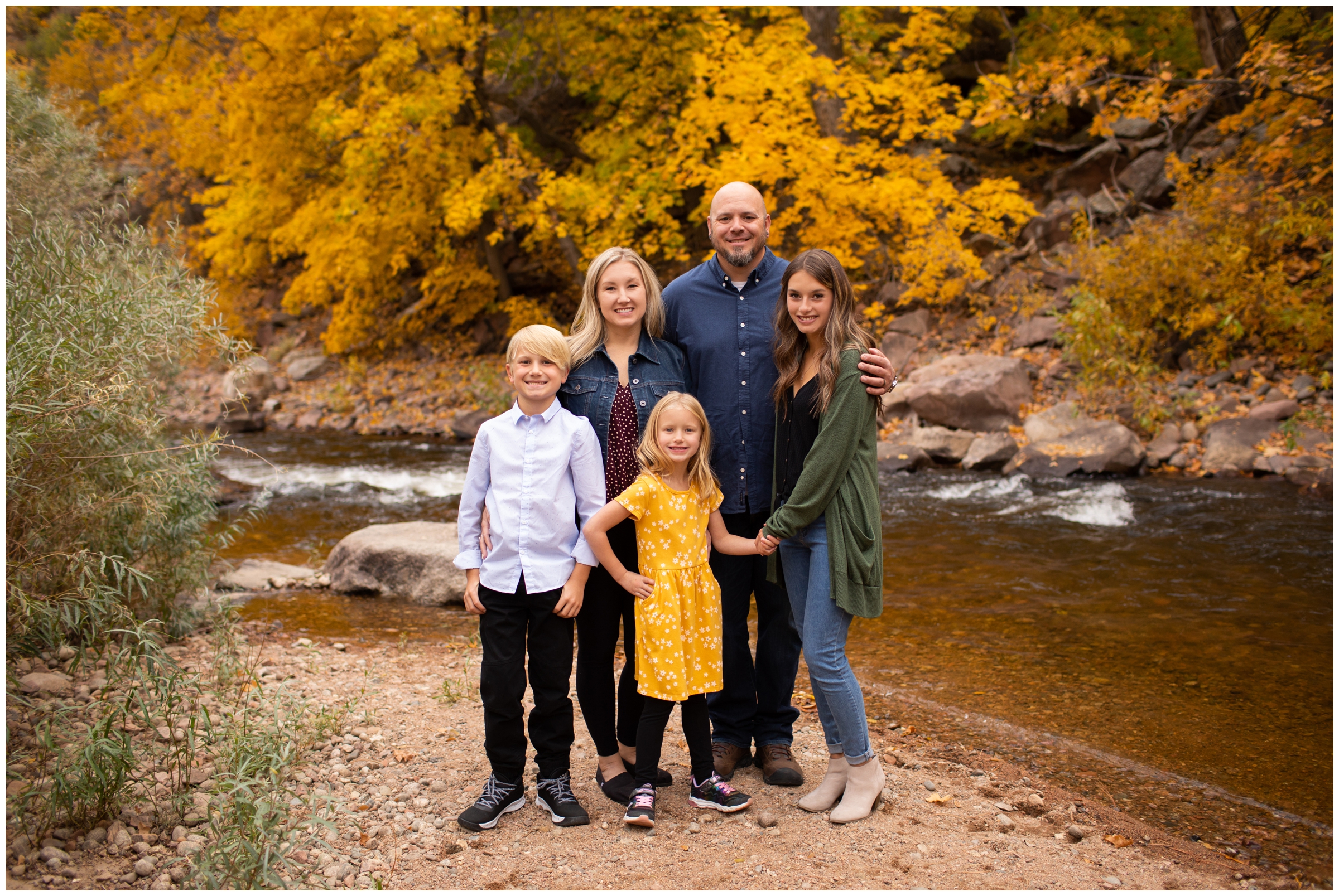 family posing by the river at Lavern Johnson Park during Lyons Colorado family portraits 