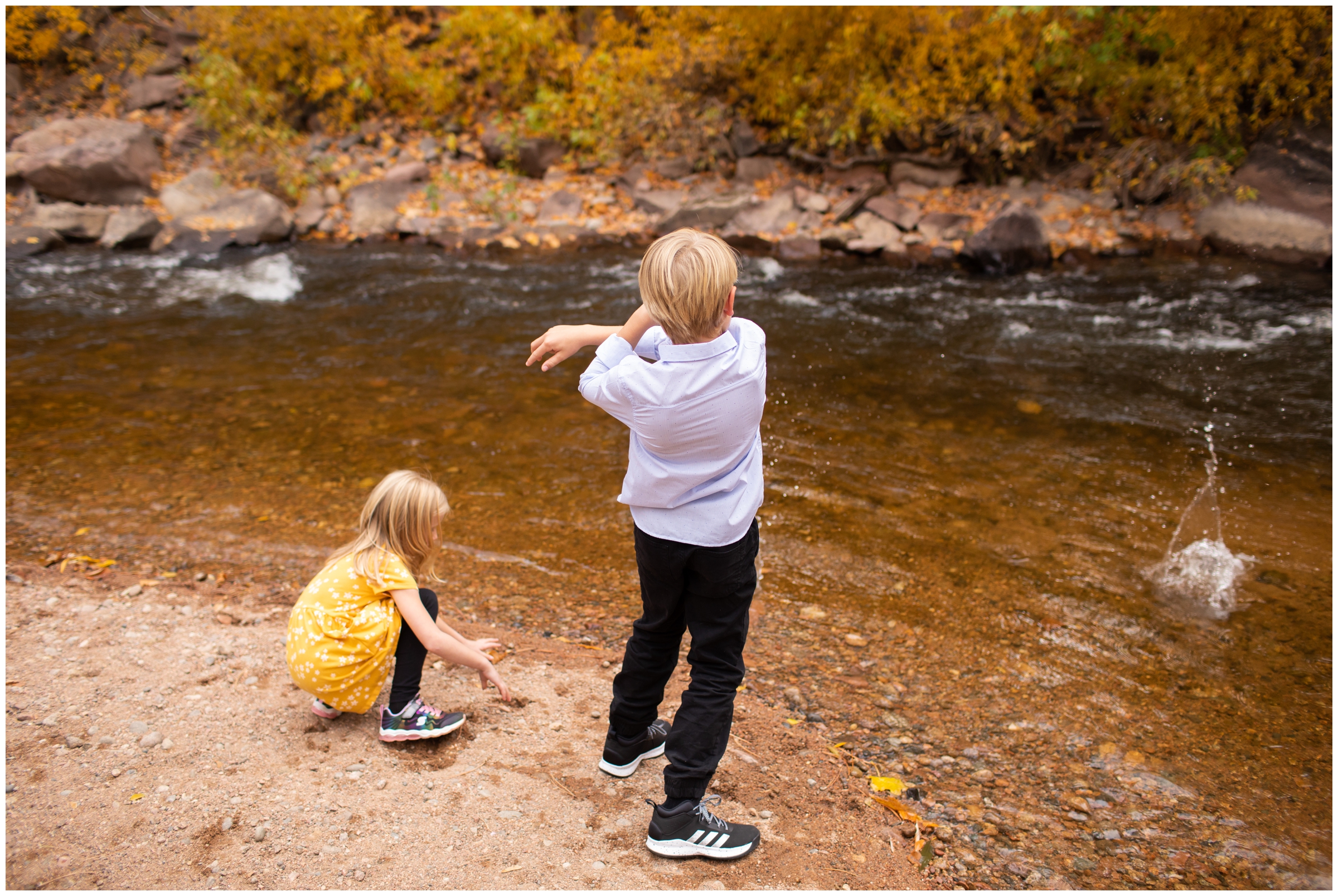 boy skipping stones during candid family photo session in Colorado mountains 