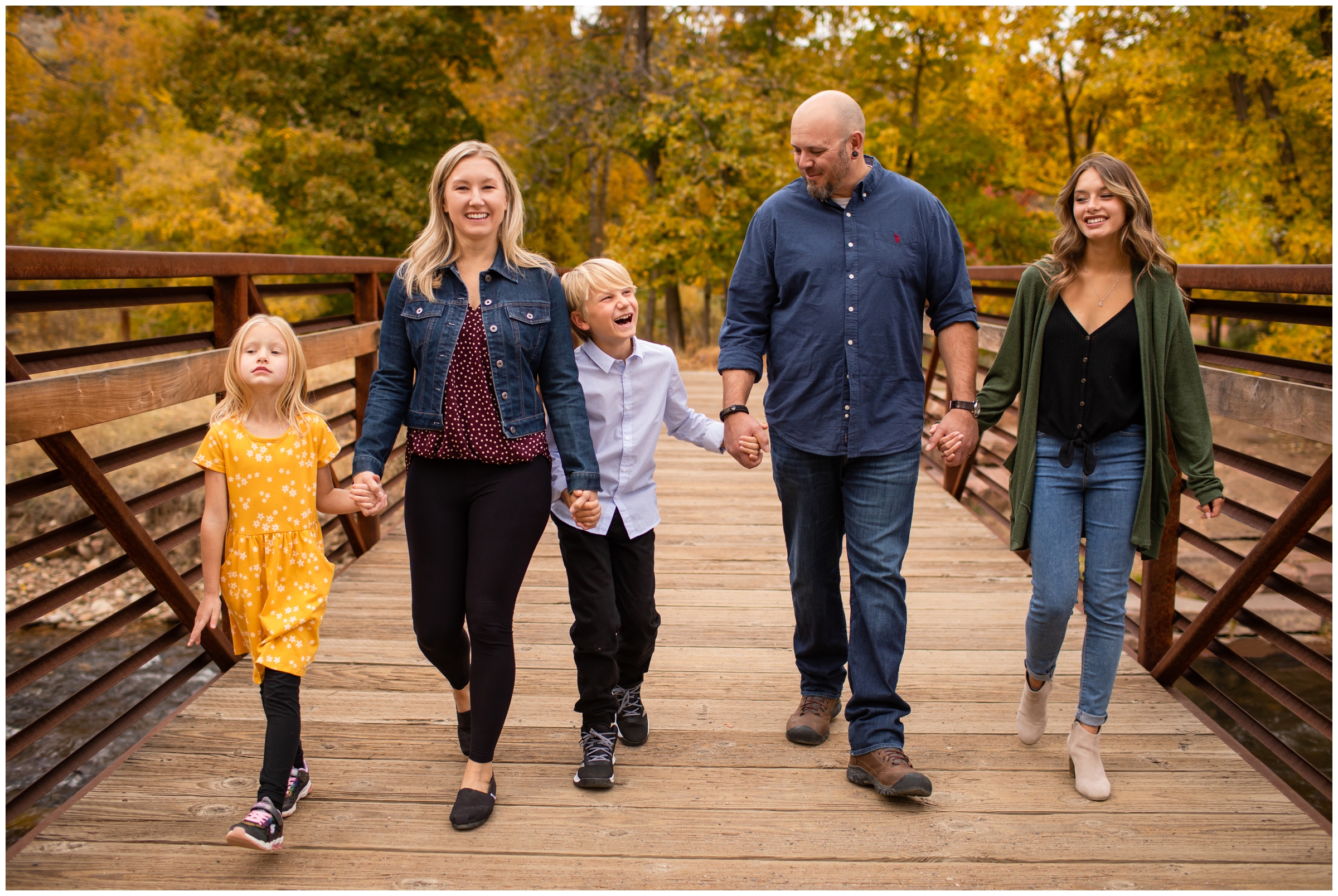 family walking on bridge during candid Lyons Colorado family photography session 