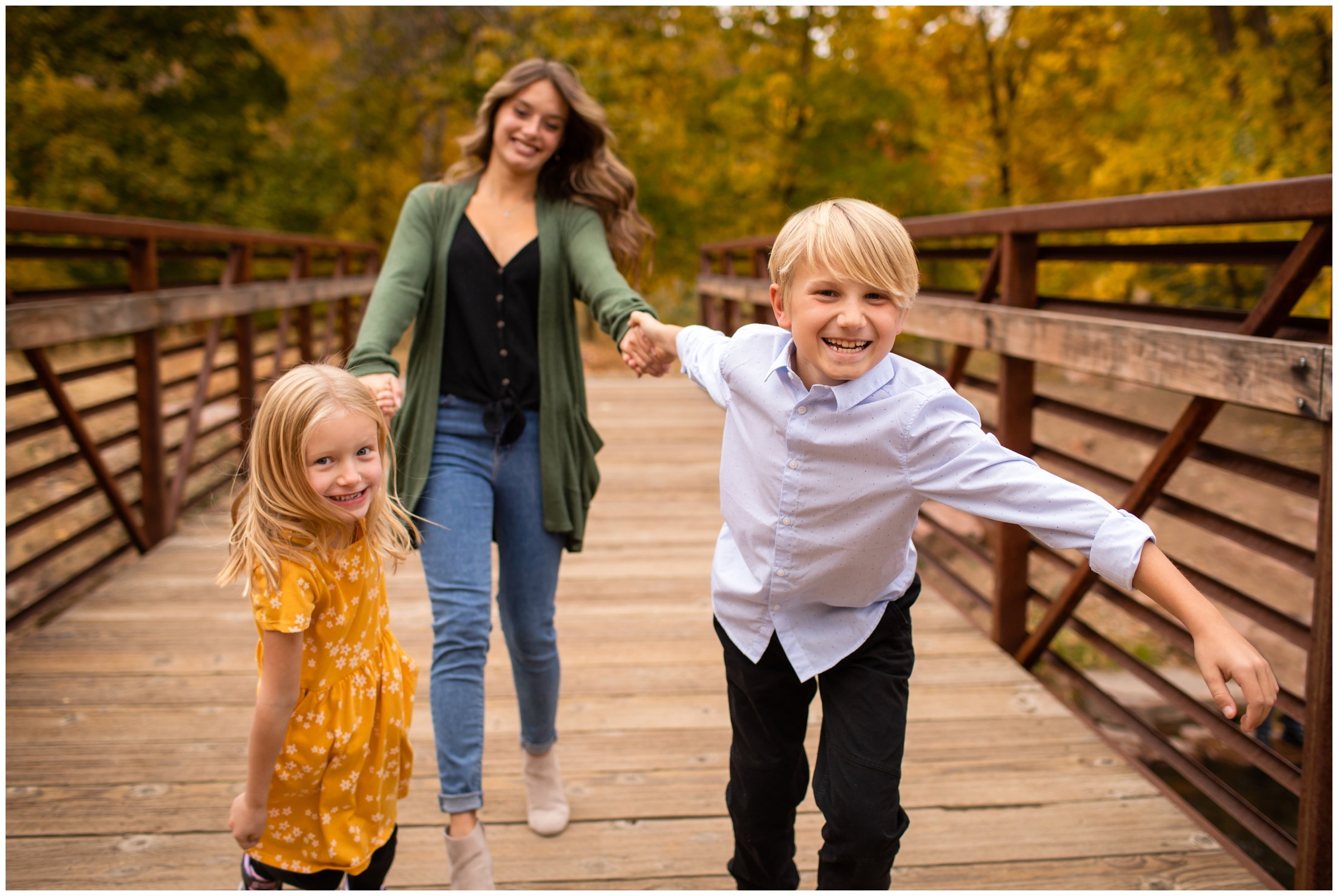 kids running on bridge during Lyons family pictures at Lavern M Johnson Park by Colorado portrait photographer Plum Pretty Photography