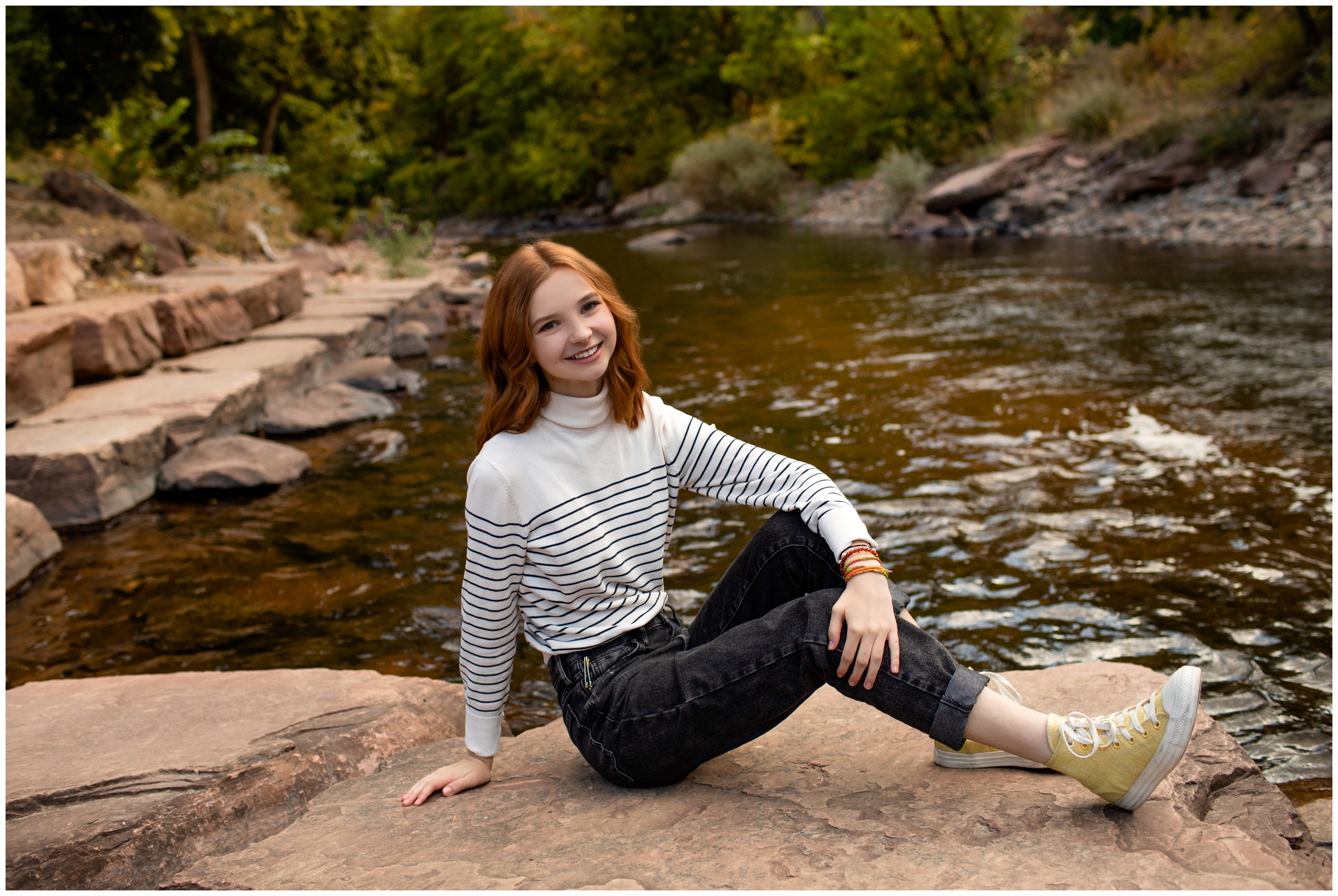teen girl posing next to river during Lyons senior photos at Lavern M. Johnson Park by Colorado portrait photographer Plum Pretty Photography