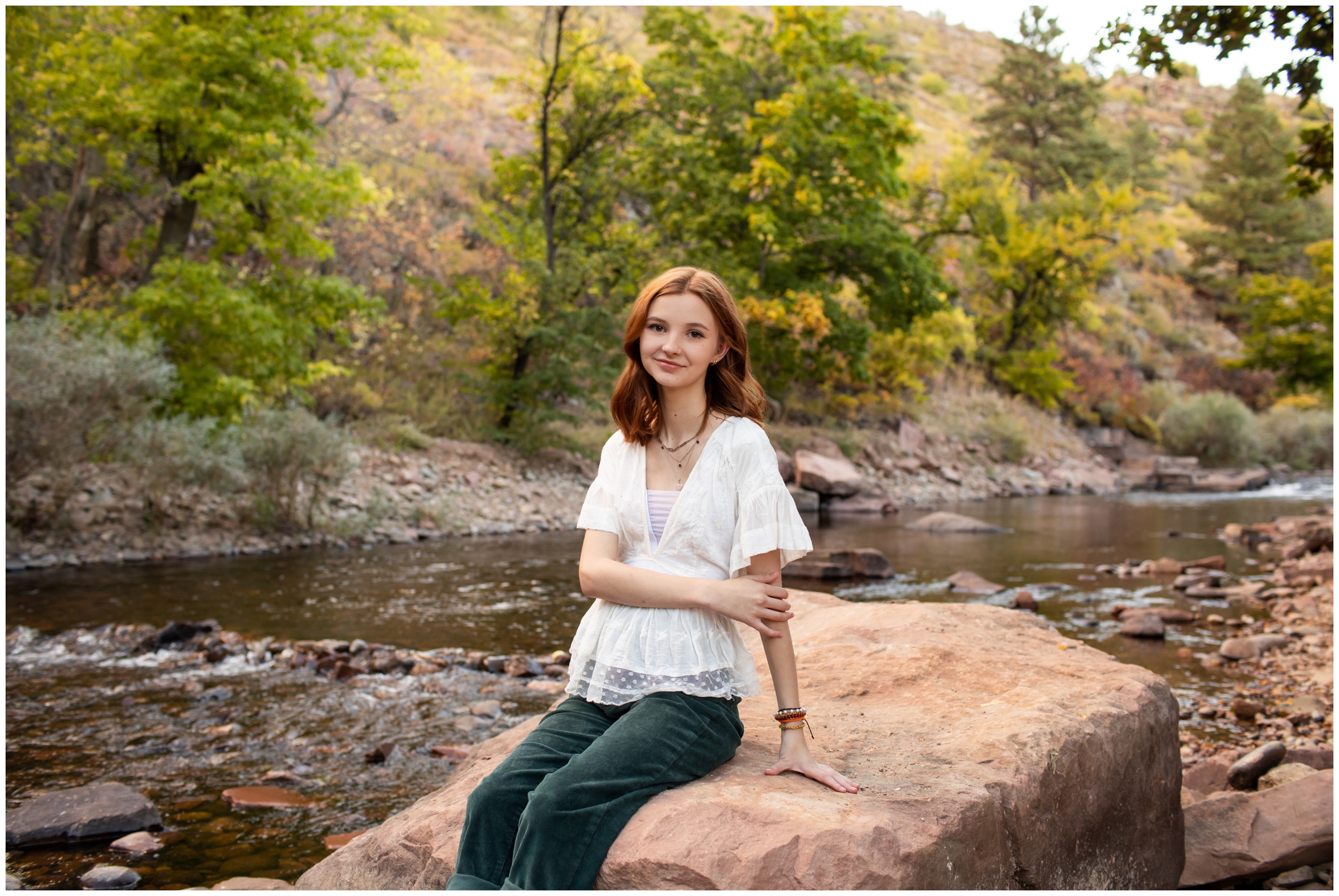 teen posing next to a river during Colorado high school senior photography session 