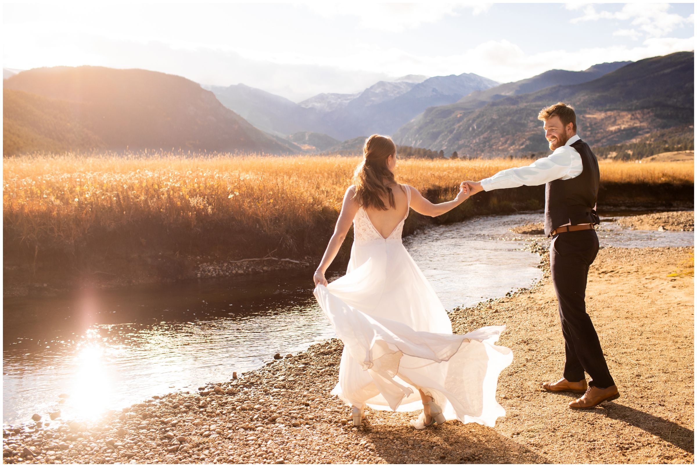 groom spinning bride next to the river at Moraine Park during RMNP elopement wedding photos in Estes Park Colorado 