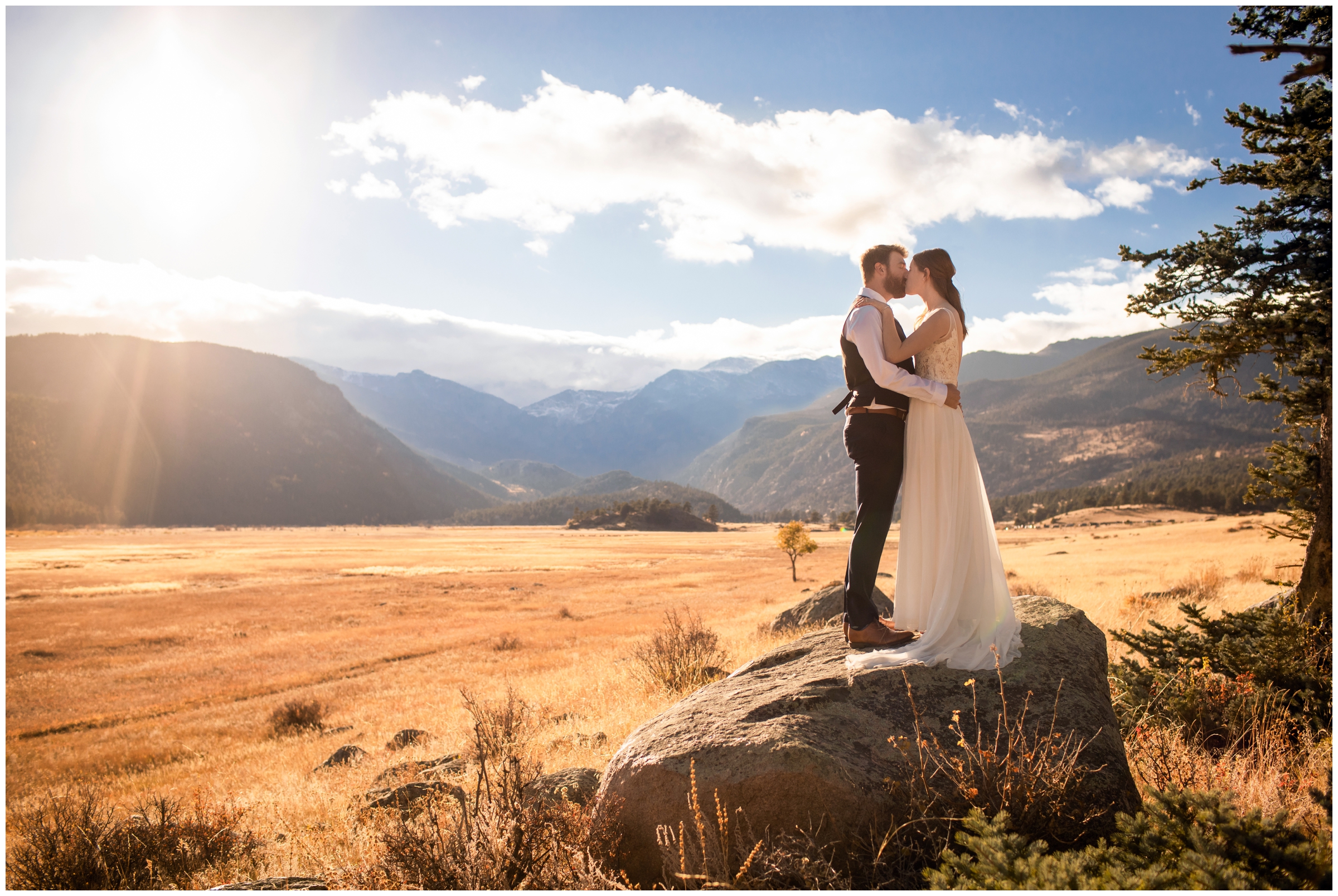couple standing on giant boulder during Colorado newlywed photo shoot at Moraine Park in Estes Park 