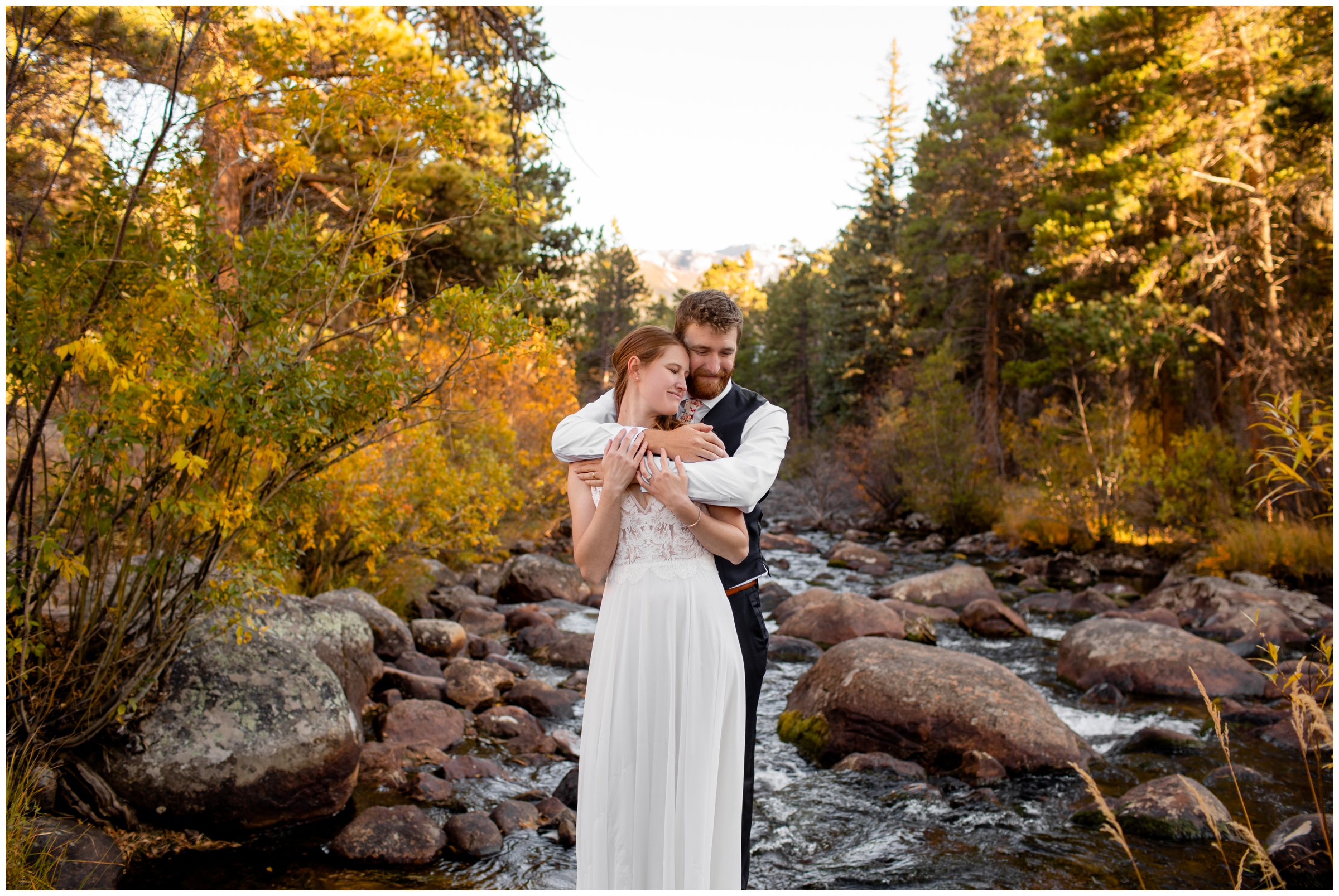 couple cuddling next to a river in Estes Park during Colorado elopement pictures