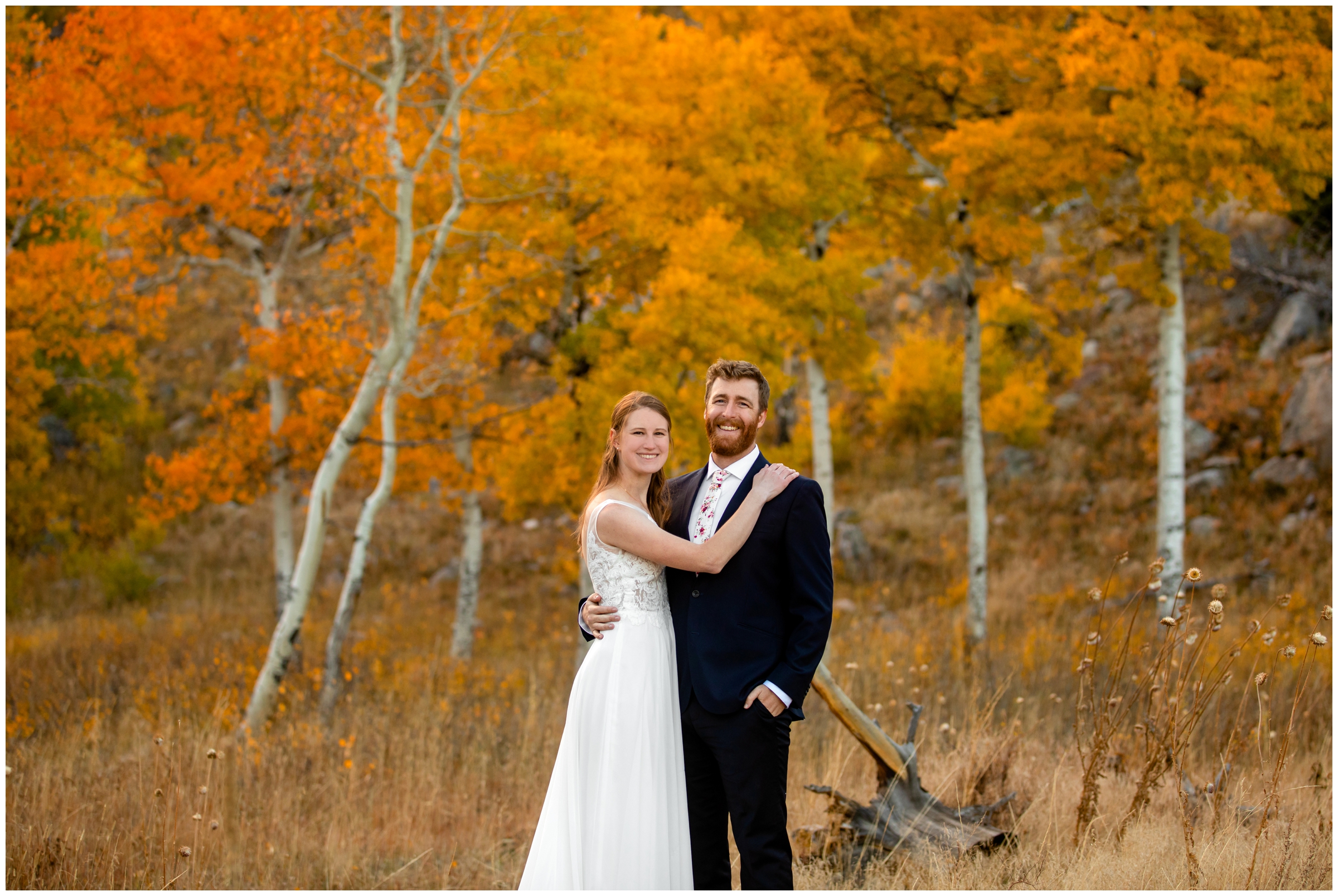 couple posing in front of aspen grove during fall wedding pictures in Estes Park Colorado 