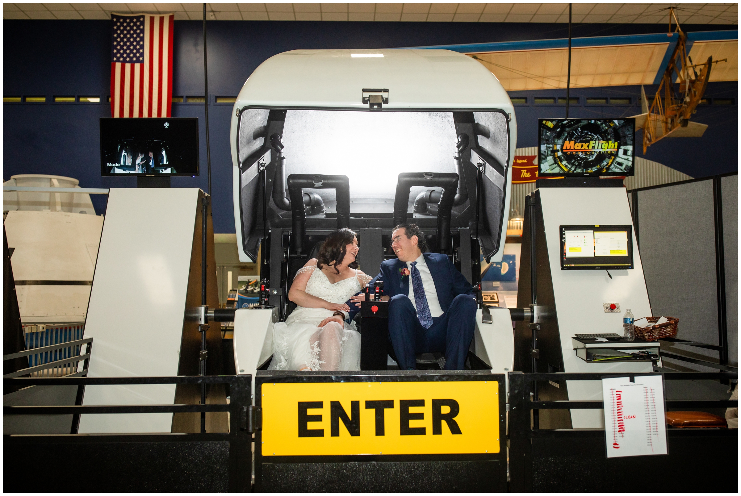 bride and groom sitting in flight simulator during unique wedding at Wings over the Rockies airplane museum wedding 