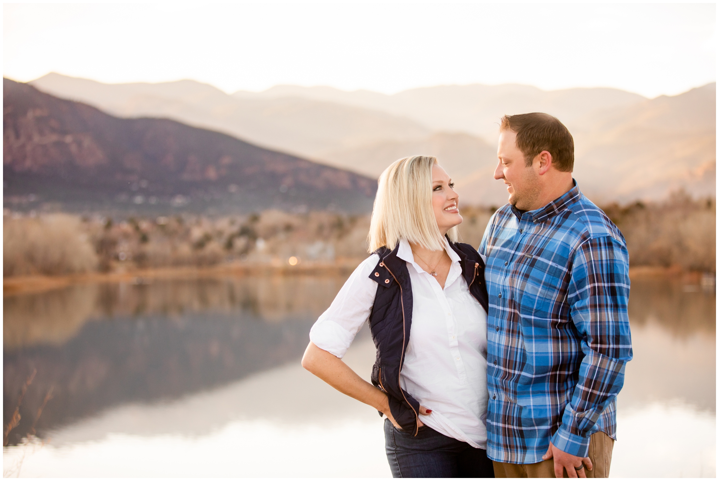 couple posing next to mountain lake during CO anniversary photos 