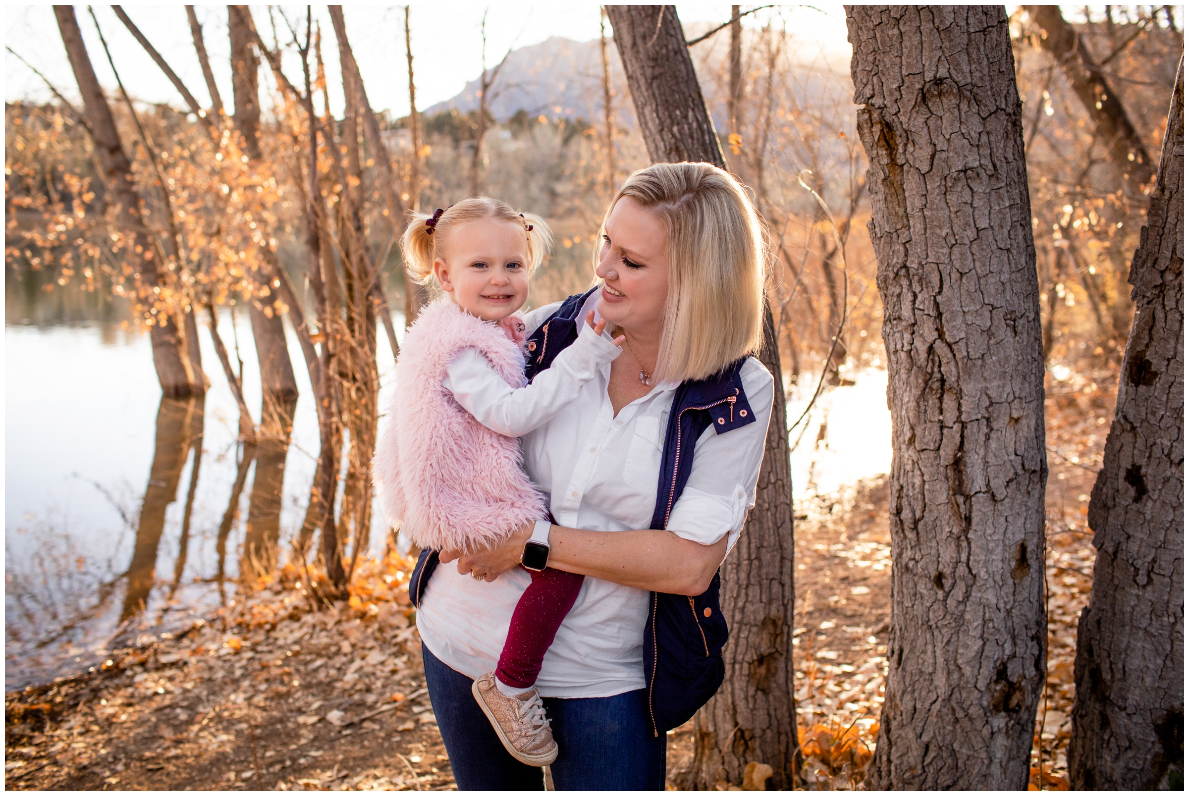 mom holding daughter during fall family photo session in Colorado Springs 