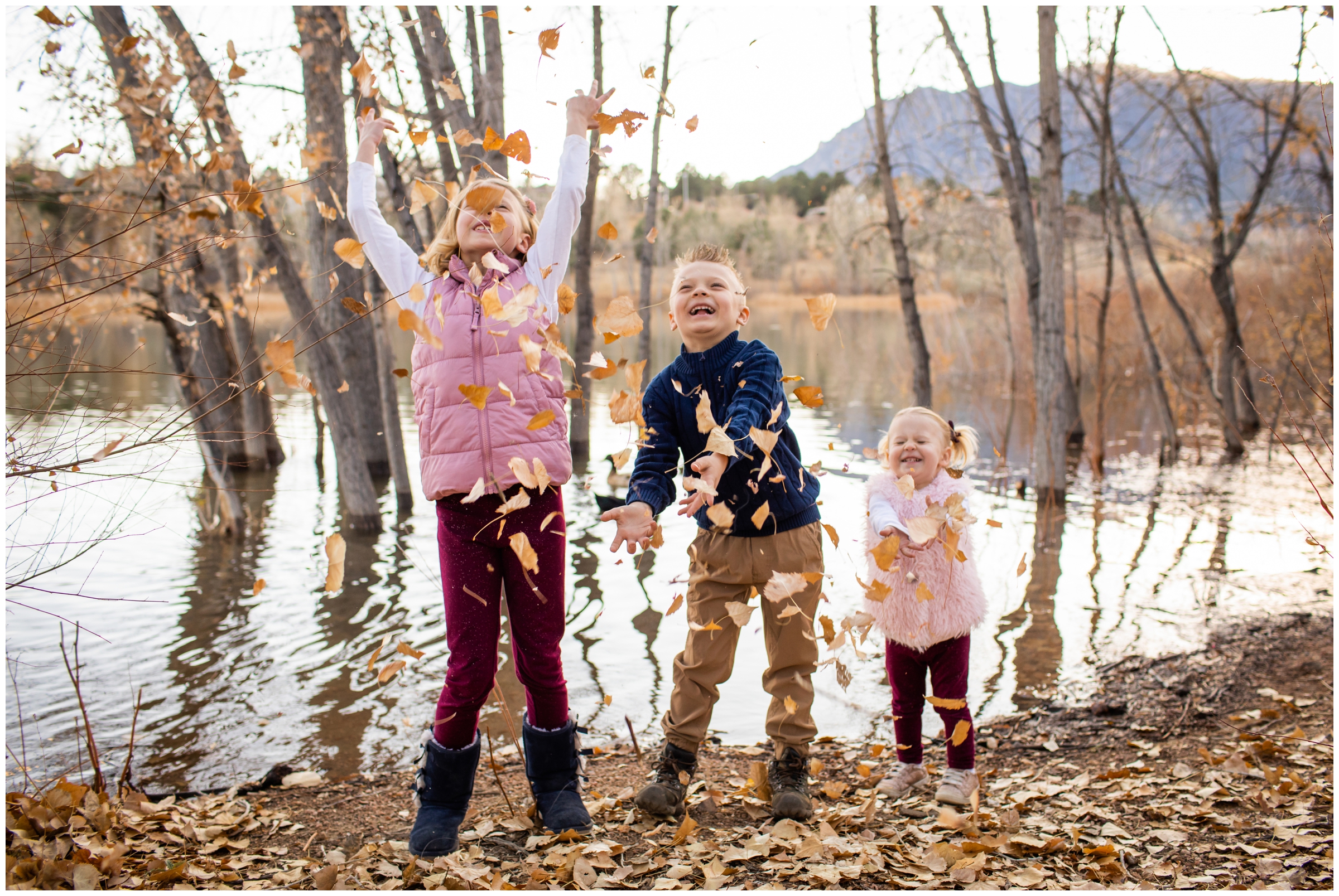kids throwing leaves in the air during candid family pictures in Colorado Springs 