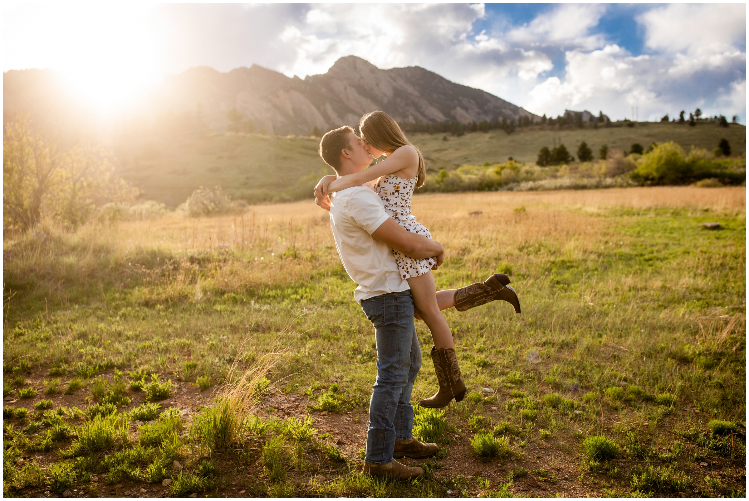 guy lifting his fiancé during spring engagement photos at South Mesa Trail in Colorado