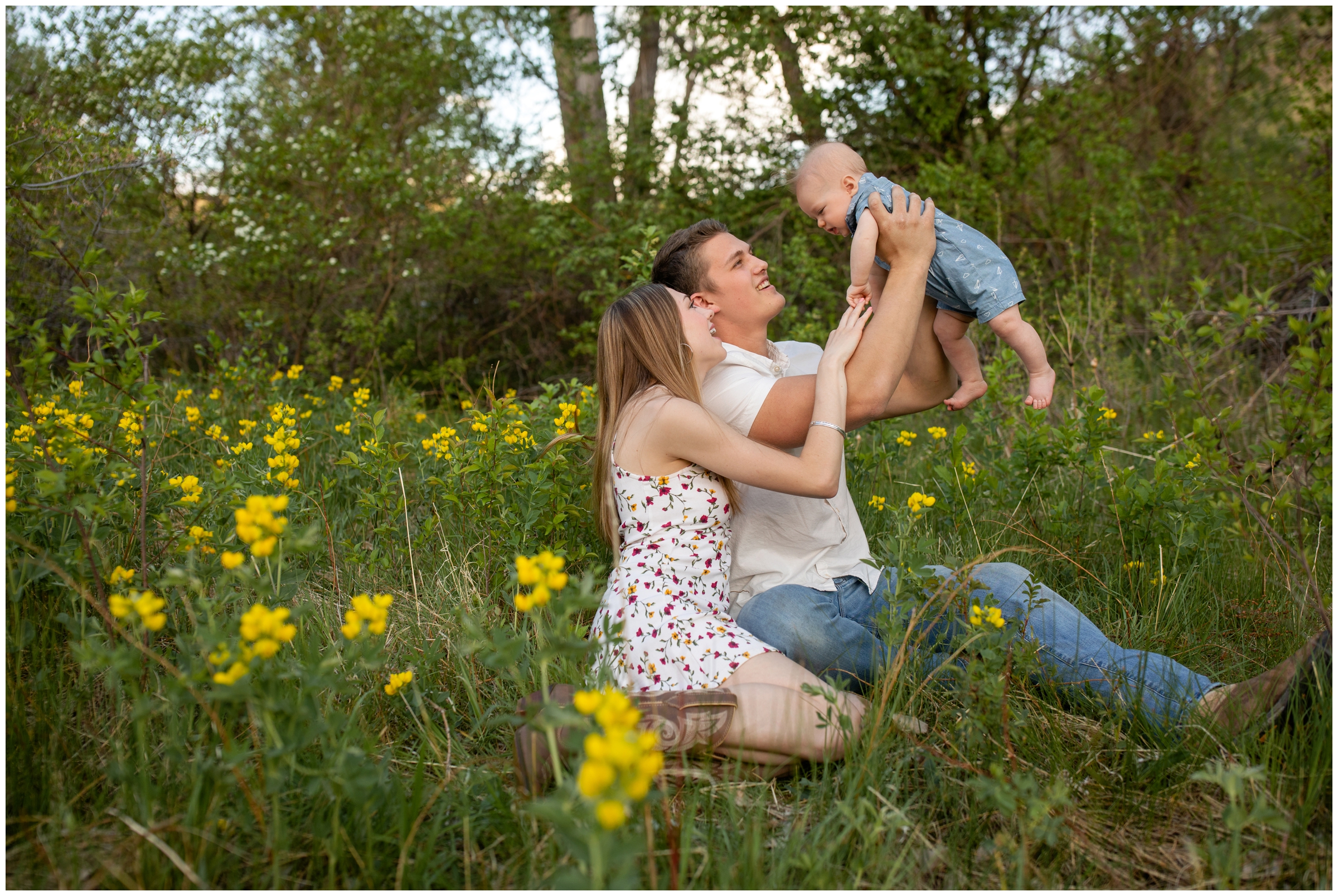 couple lifting son in the air during candid family photos in Boulder Colorado