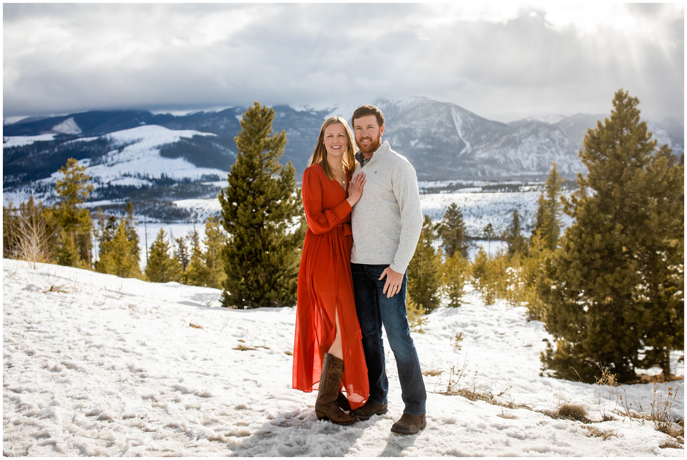 couple posing in snow with mountains in background at Sapphire Point Overlook
