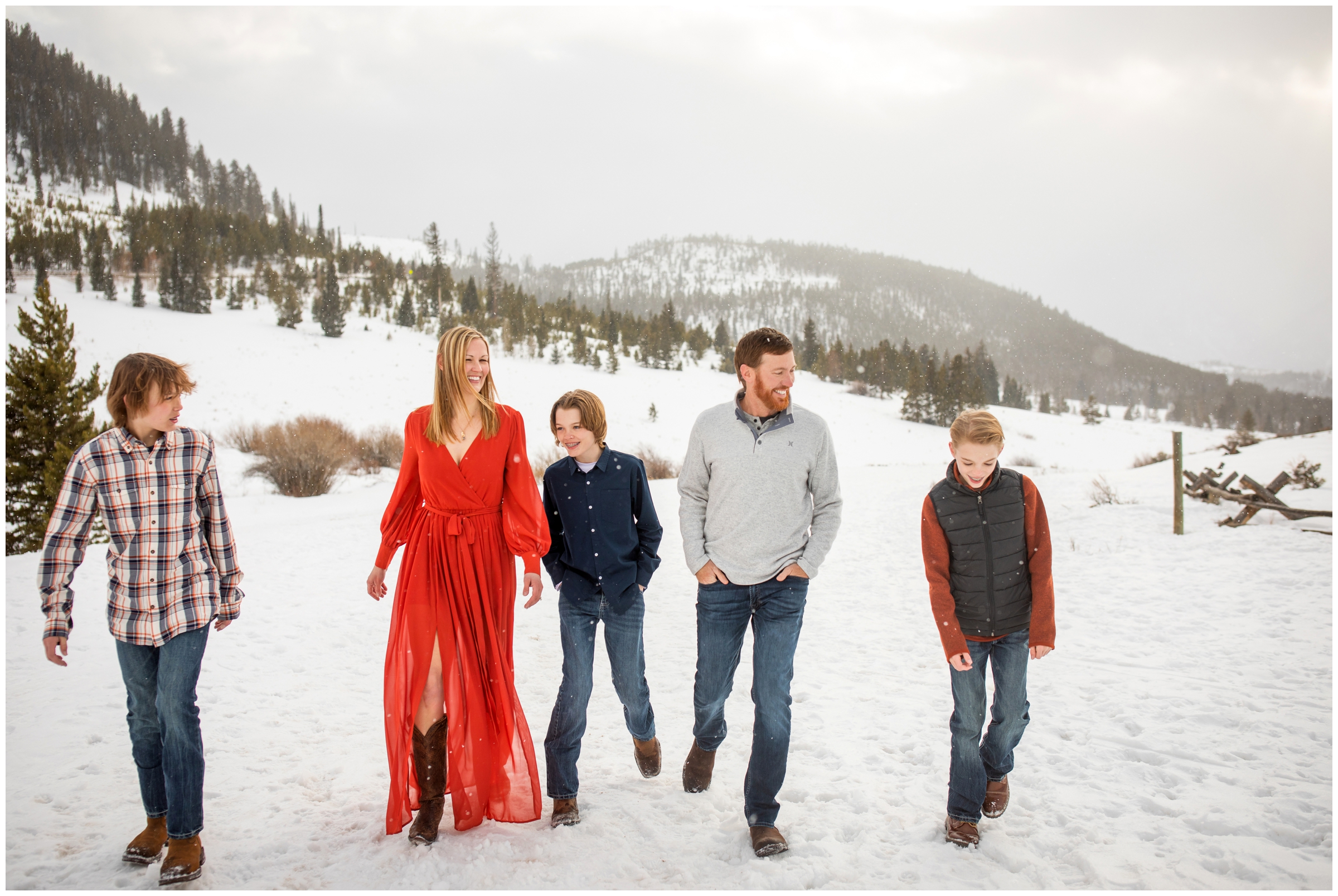 family walking in the snow during candid family photos at Windy Point Campground in Breckenridge Colorado