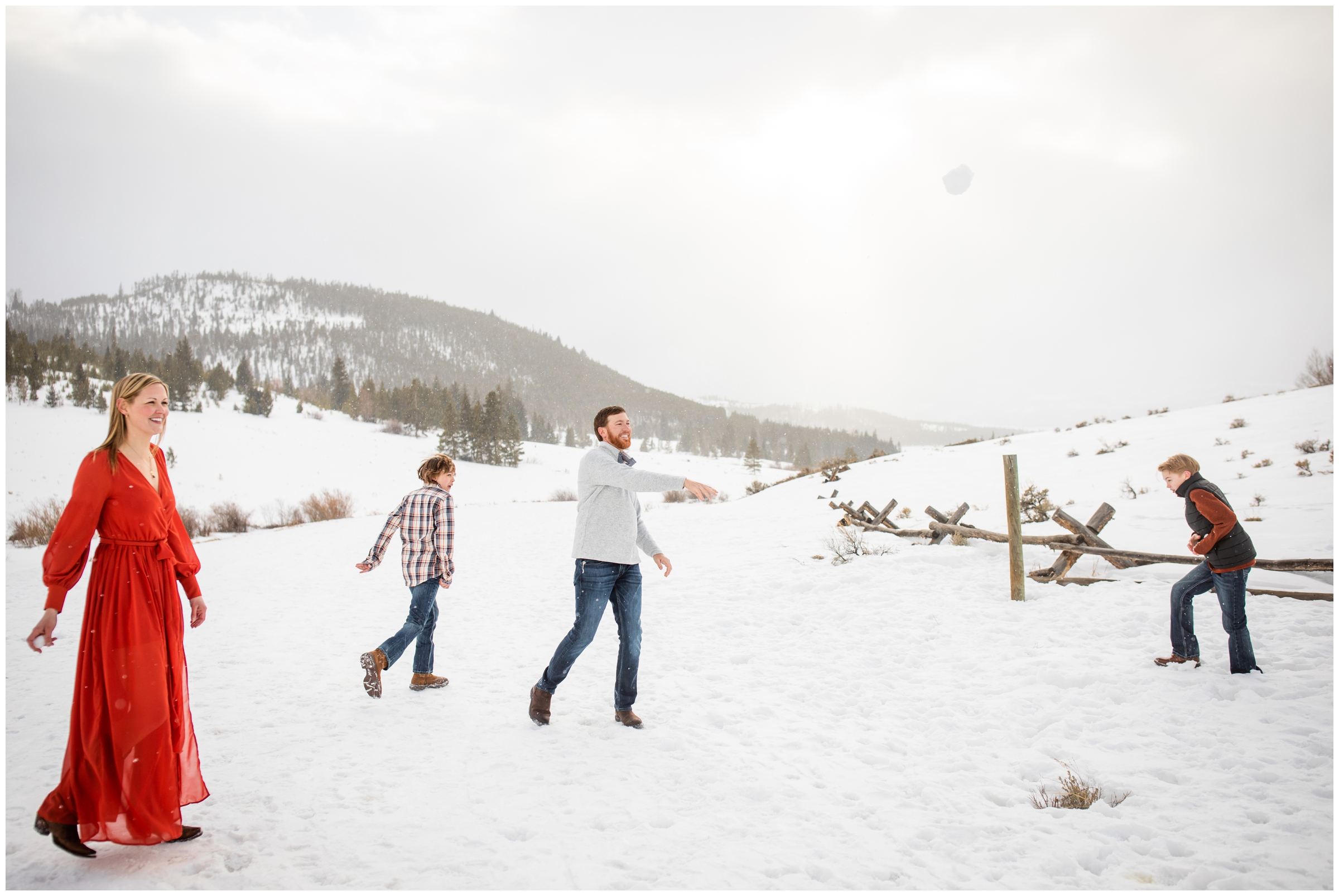 family having a snowball fight during candid family pictures in the Colorado mountains