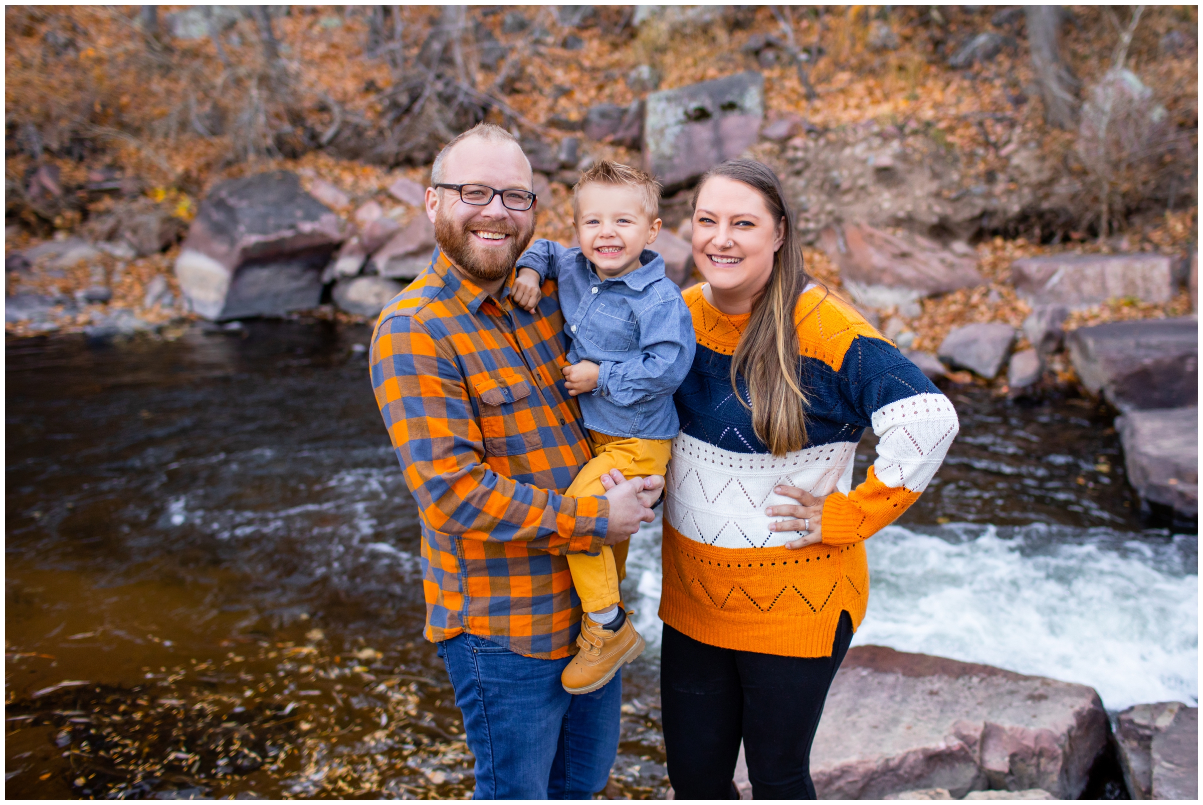 family posing by the river at the Lavern Johnson Park in Lyons CO