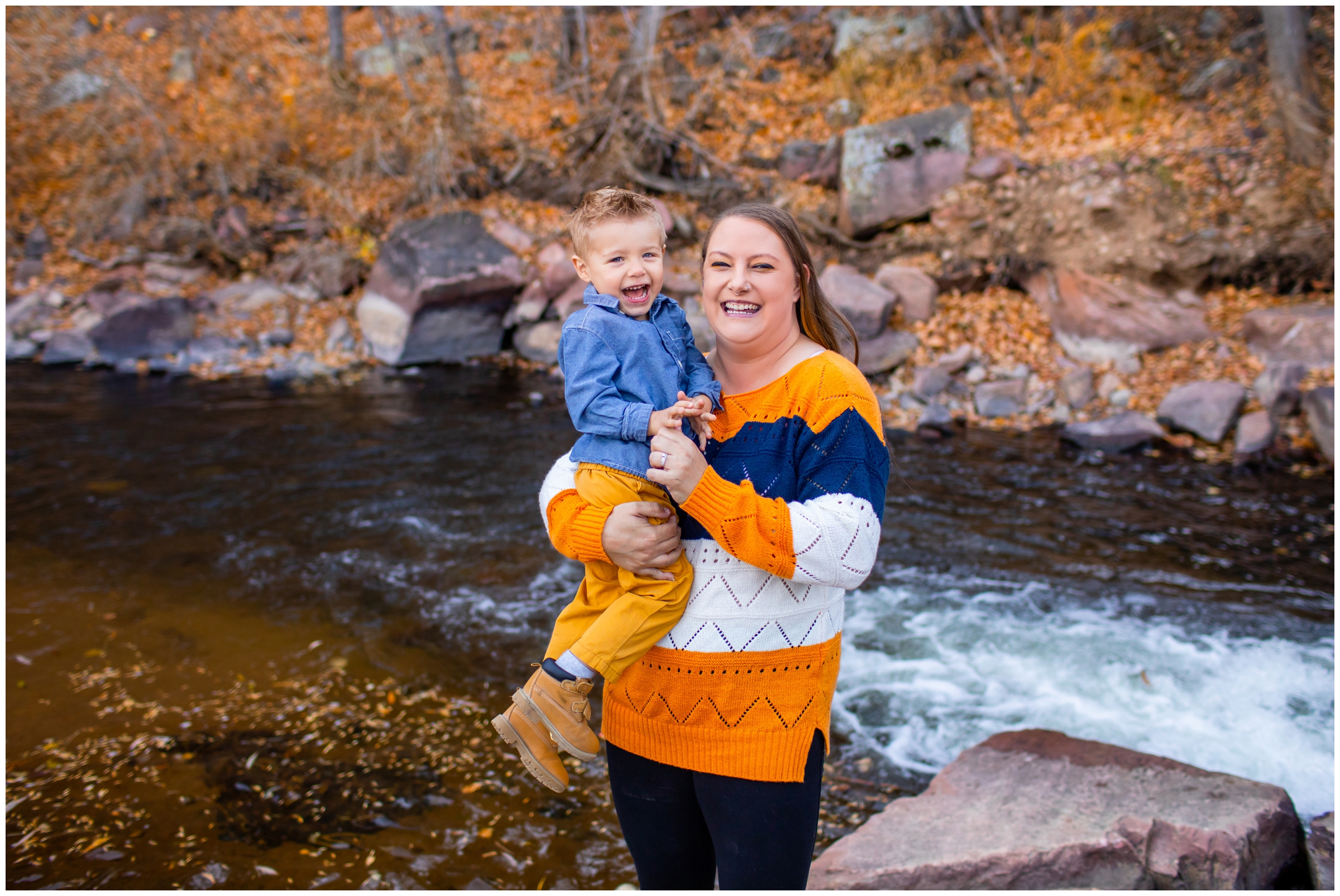 mom holding son next to a river during Lyons Colorado fall family mini session 