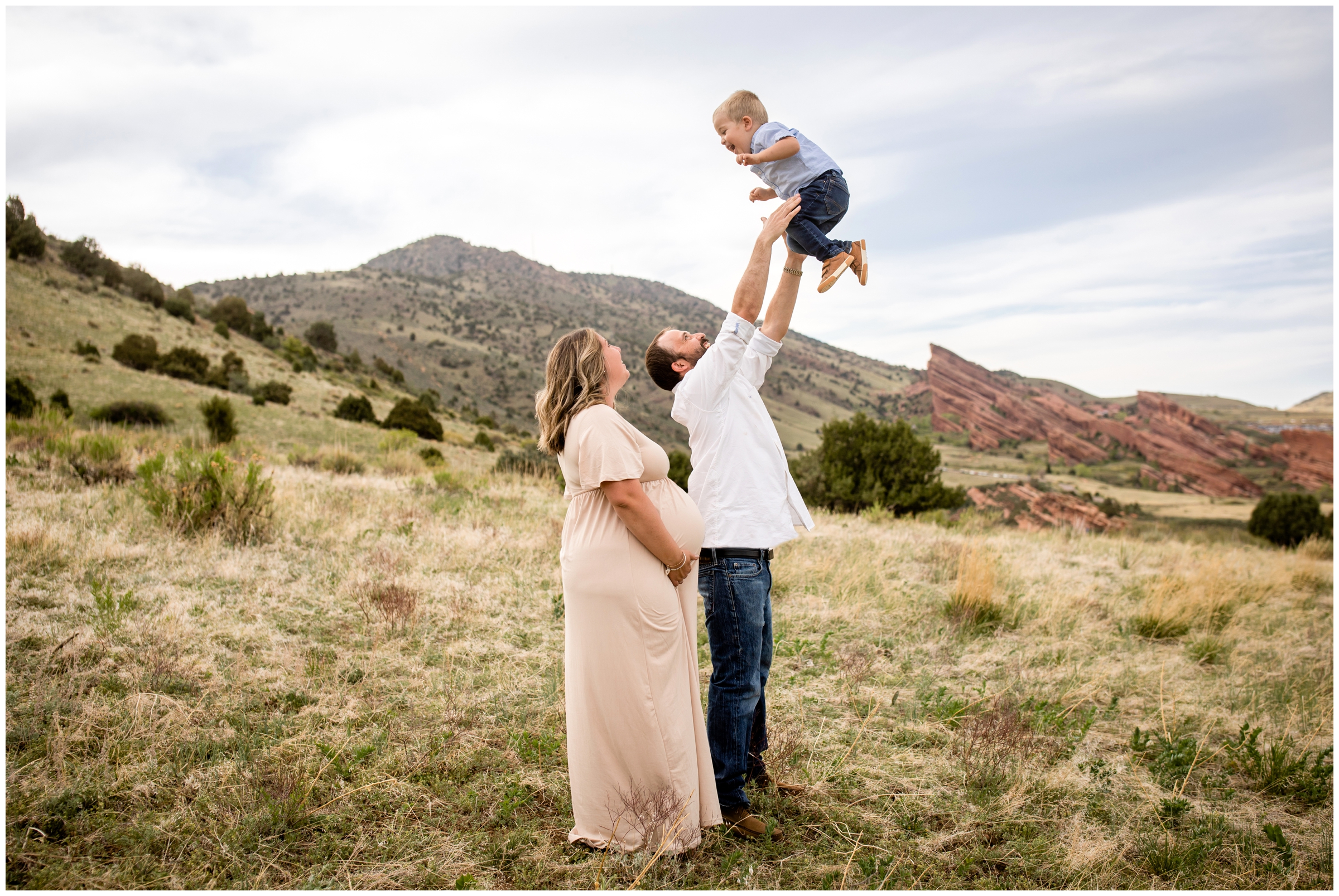 dad lifting son in the air during candid family photography session in Colorado foothills